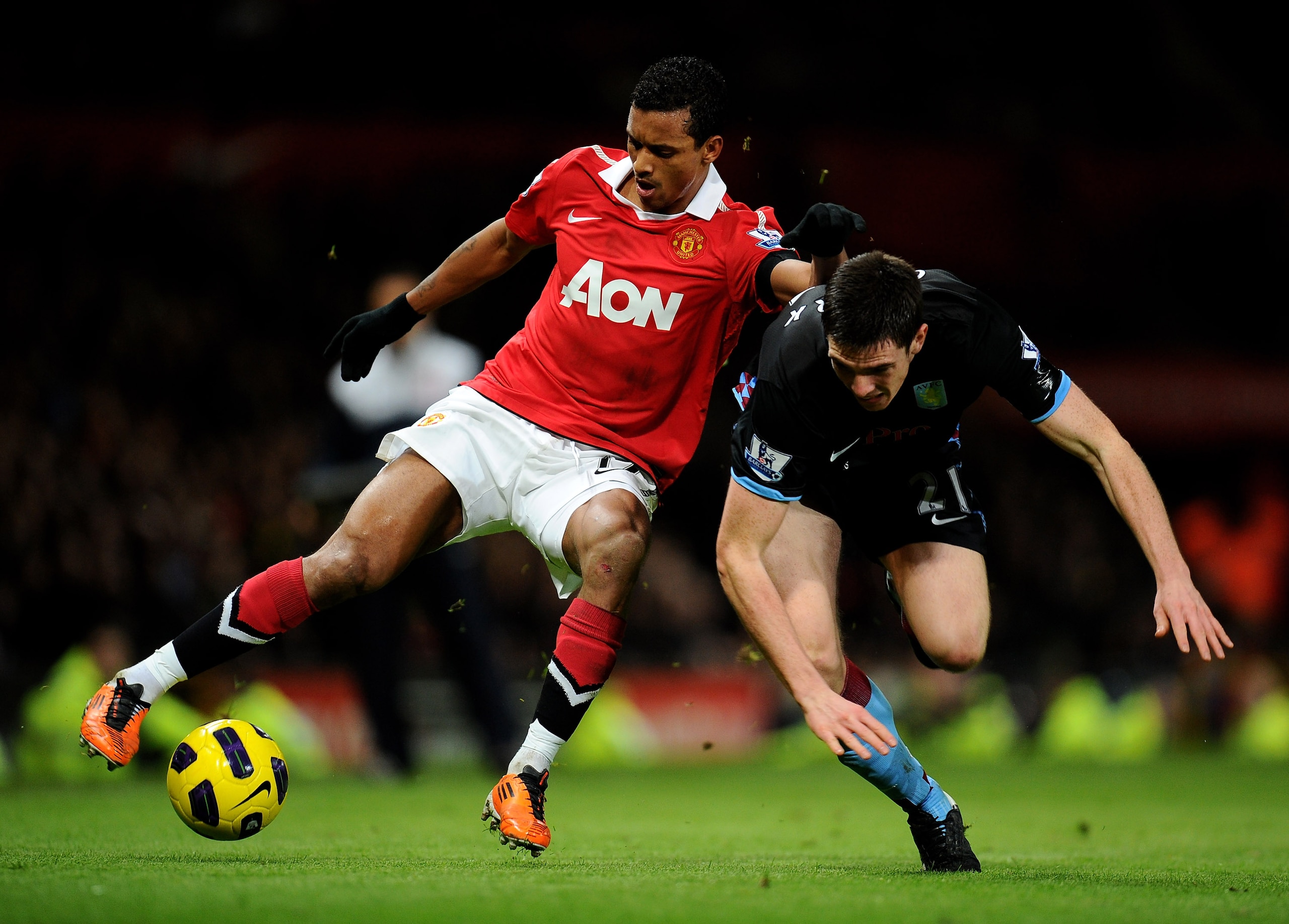 MANCHESTER, ENGLAND - FEBRUARY 01:  Ciaran Clark of Aston Villa tangles with Nani of Manchester United during the Barclays Premier League match between Manchester United and Aston Villa at Old Trafford on February 1, 2011 in Manchester, England.  (Photo b