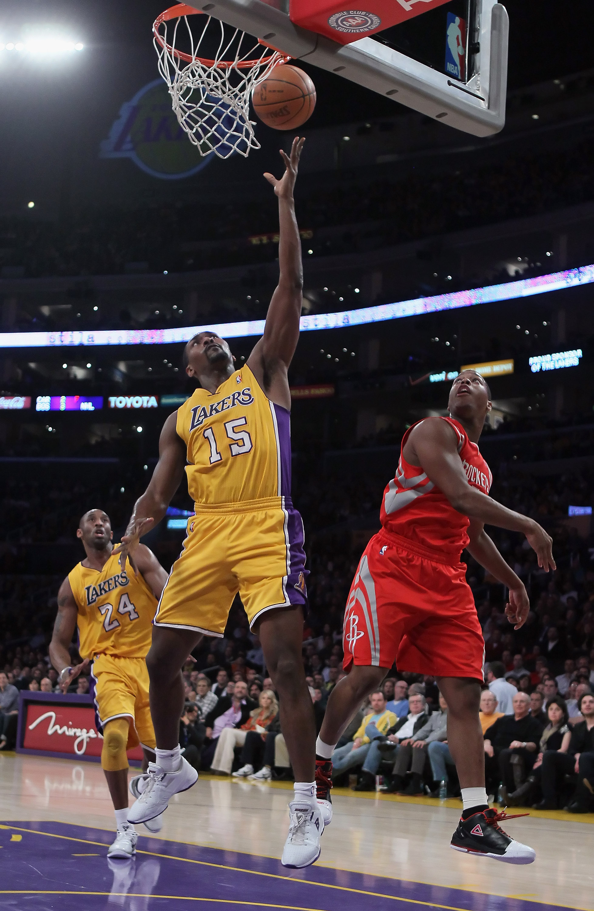 LOS ANGELES, CA - FEBRUARY 01:  Ron Artest #15 of the Los Angeles Lakers drives to the basket past Kyle Lowry #7 of the Houston Rockets in the first half at Staples Center on February 1, 2011 in Los Angeles, California. NOTE TO USER: User expressly acknow
