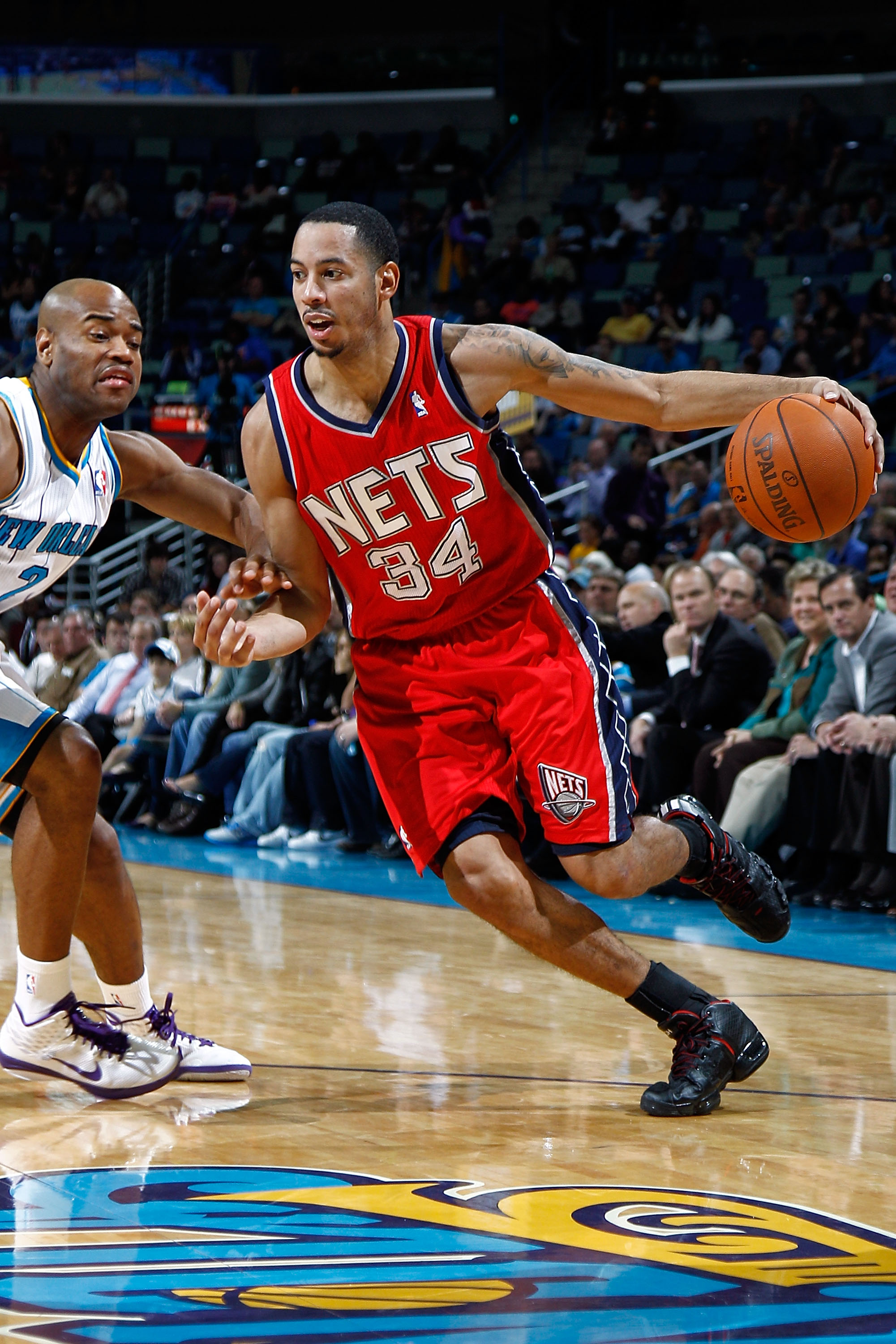NEW ORLEANS, LA - DECEMBER 22:  Devin Harris #34 of the New Jersey Nets drives the ball around Jarrett Jack #2  of the New Orleans Hornets at the New Orleans Arena on December 22, 2010 in New Orleans, Louisiana.    The Hornets defeated the Nets 105-91.   