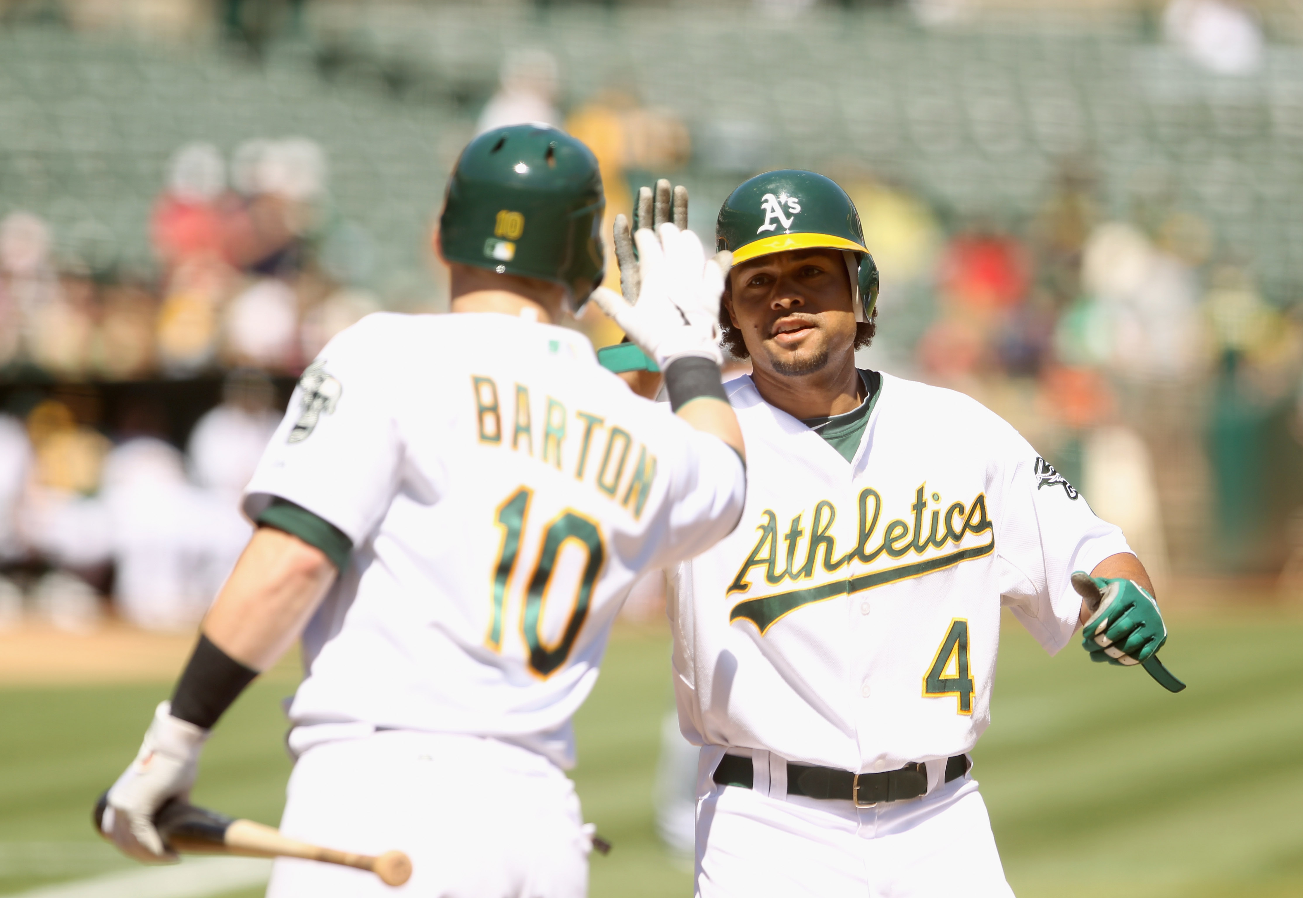 OAKLAND, CA - SEPTEMBER 06:  Coco Crisp #4 of the Oakland Athletics is congratulated by Daric Barton #10 after Crisp hit a lead off home run against the Seattle Mariners at the Oakland-Alameda County Coliseum on September 6, 2010 in Oakland, California.