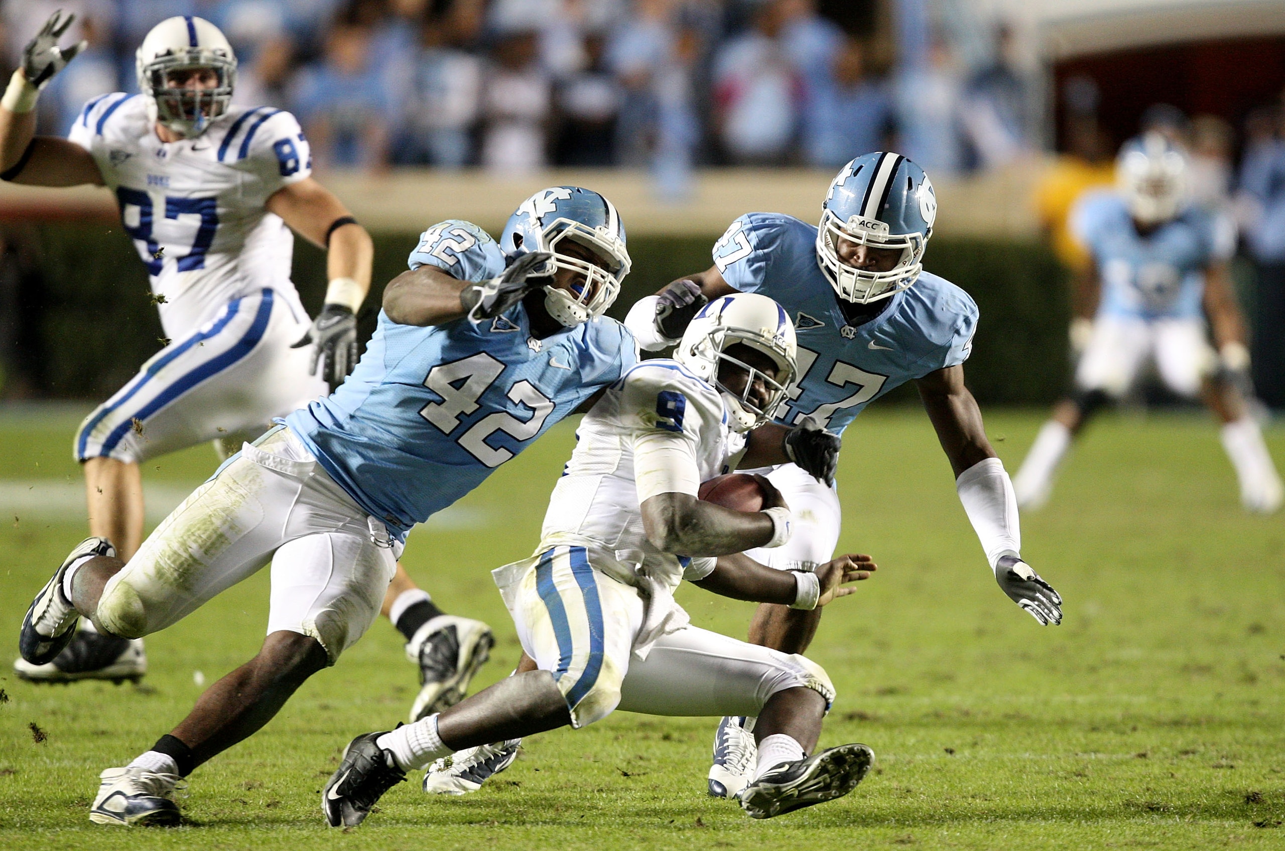 CHAPEL HILL, NC - NOVEMBER 07:  Thaddeus Lewis #9 of the Duke Blue Devils is sacked by Robert Quinn #42 of the North Carolina Tar Heels during their game at Kenan Stadium on November 7, 2009 in Chapel Hill, North Carolina.  (Photo by Streeter Lecka/Getty 