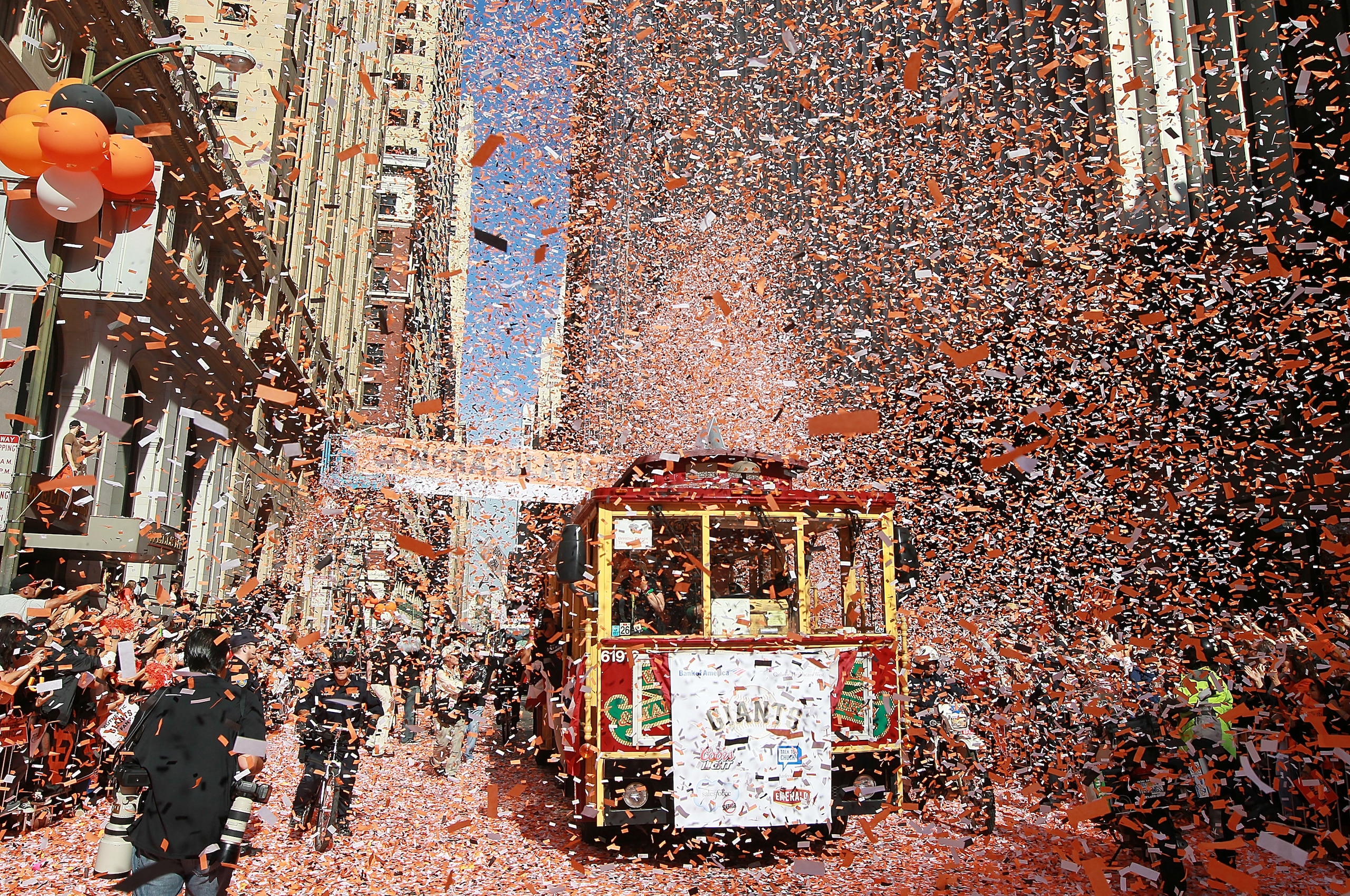 SAN FRANCISCO - NOVEMBER 03:  A cable car carrying members of the San Francisco Giants gets covered with confetti during the Giants' vicotry parade on November 3, 2010 in San Francisco, California. Thousands of Giants fans lined the streets of San Francis