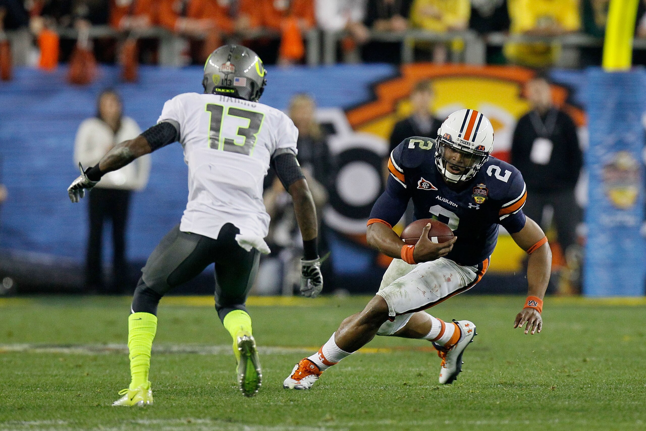 GLENDALE, AZ - JANUARY 10:  Cameron Newton #2 of the Auburn Tigers runs down field against Cliff Harris #13 of the Oregon Ducks during the Tostitos BCS National Championship Game at University of Phoenix Stadium on January 10, 2011 in Glendale, Arizona.  