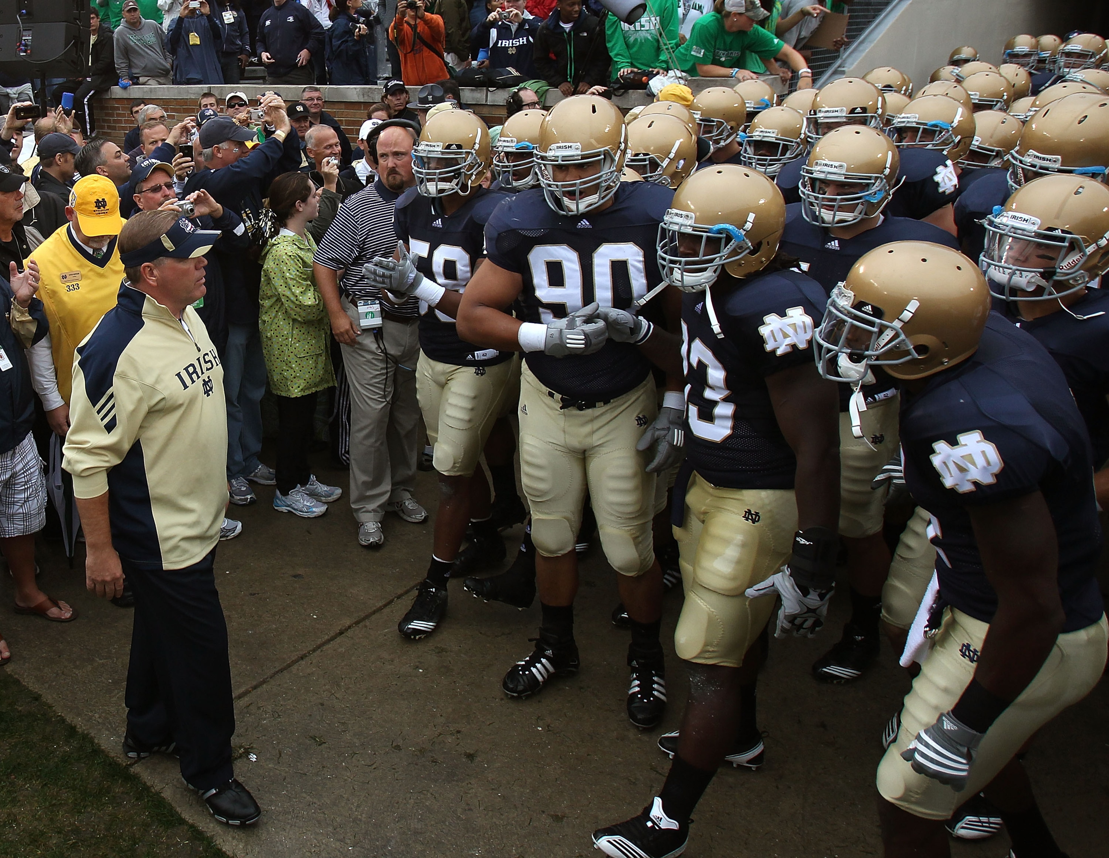SOUTH BEND, IN - SEPTEMBER 11: Head coach Brian Kelly of the Notre Dame Fighting Irish (L) waits to enter the field with his team before a game against the Michigan Wolverines at Notre Dame Stadium on September 11, 2010 in South Bend, Indiana. Michigan de