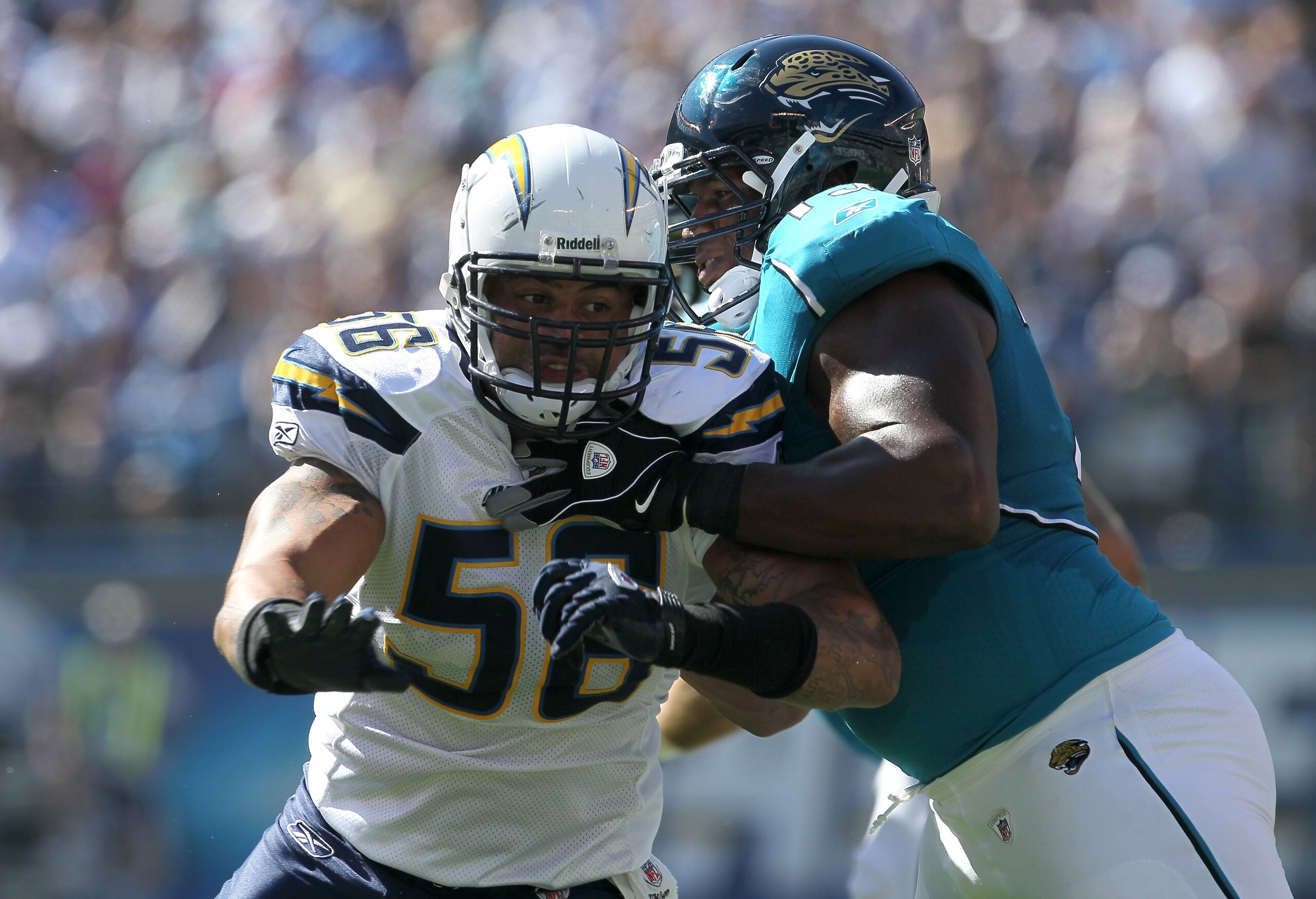 SAN DIEGO - SEPTEMBER 19:  Linebacker Shawne Merriman #56 of the San Diego Chargers fights against the block of tackle Eugene Monroe #75 of the Jacksonville Jaguars at Qualcomm Stadium on September 19, 2010 in San Diego, California. The Chargers won 38-13
