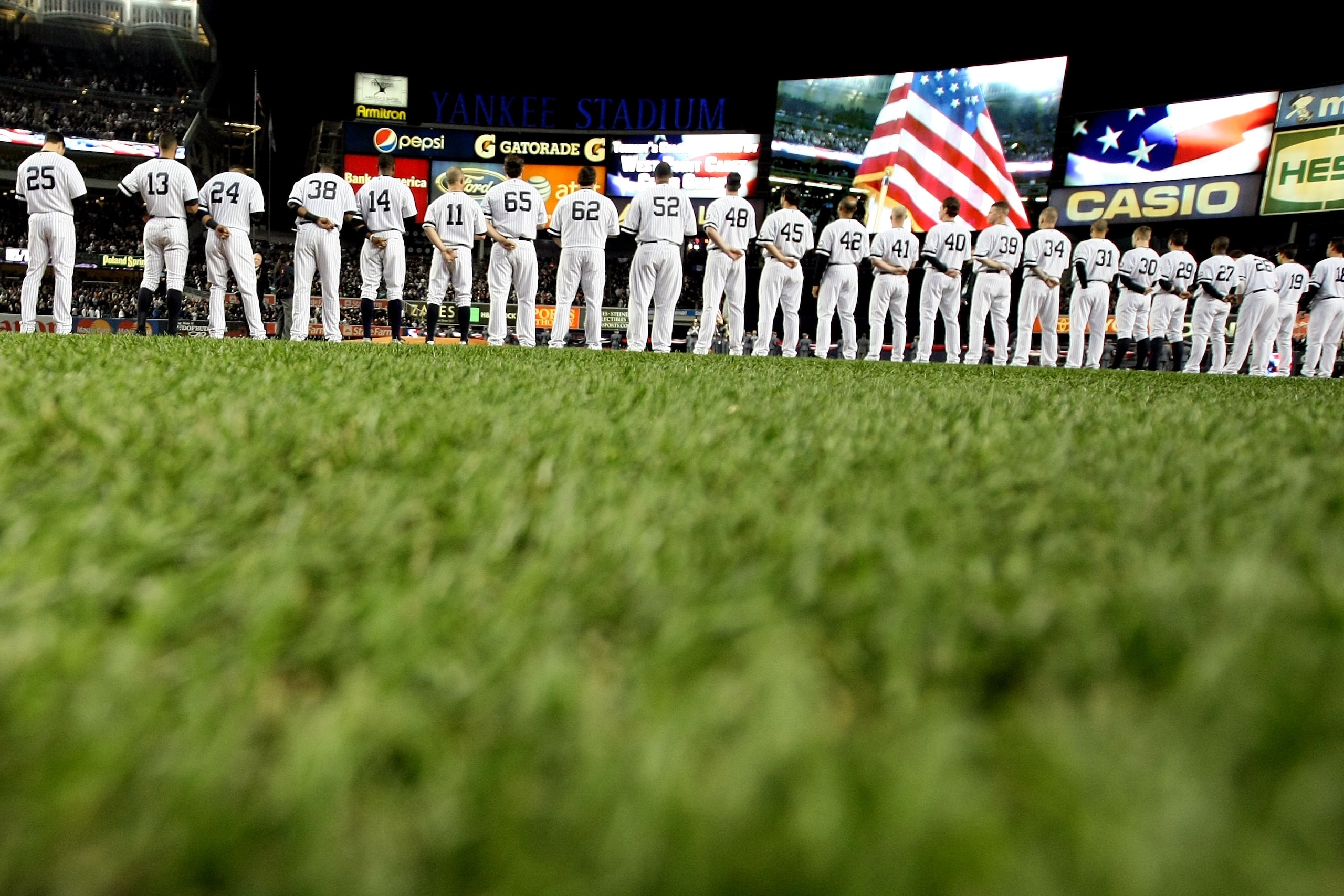 NEW YORK - OCTOBER 18: The American Flag is seen on the video screen during the National Anthem as the Yankees and Texas Rangers stand on the foul lines prior to playing in Game Three of the ALCS during the 2010 MLB Playoffs at Yankee Stadium on October NEW YORK - OCTOBER 18: The American Flag is seen on the video screen during the National Anthem as the Yankees and Texas Rangers stand on the foul lines prior to playing in Game Three of the ALCS during the 2010 MLB Playoffs at Yankee Stadium on October