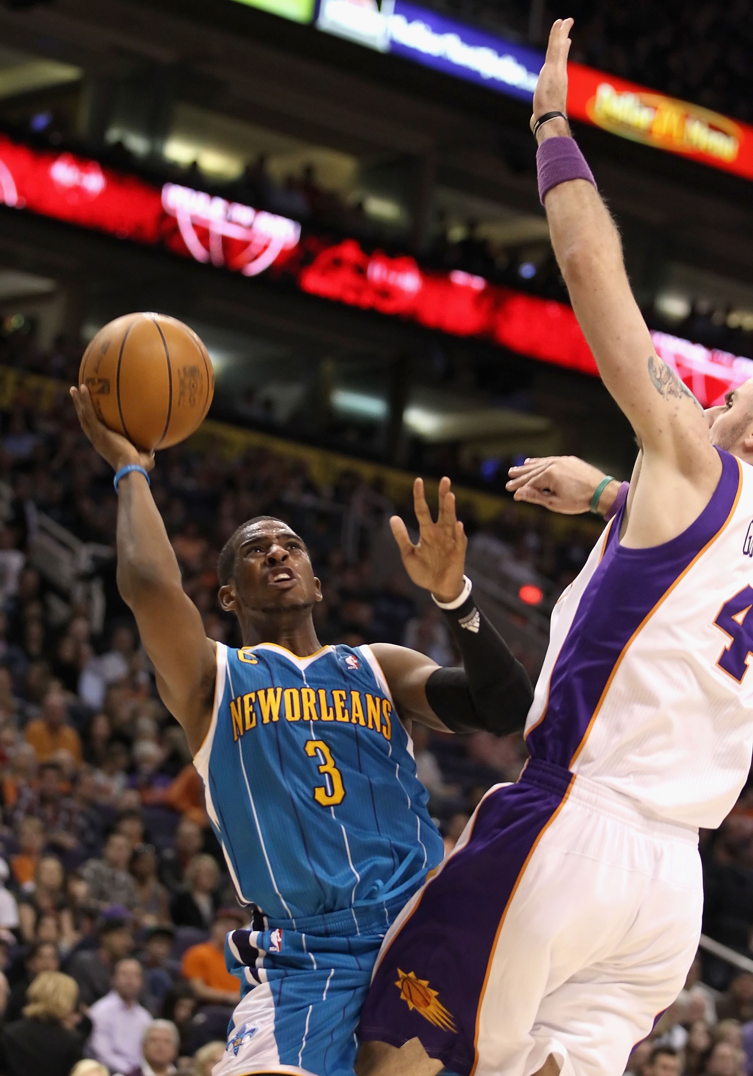 PHOENIX, AZ - JANUARY 30: Chris Paul #3 of the New Orleans Hornets puts up a shot against Marcin Gortat #4 of the Phoenix Suns during the NBA game at US Airways Center on January 30, 2011 in Phoenix, Arizona. NOTE TO USER: User expressly acknowledges an PHOENIX, AZ - JANUARY 30: Chris Paul #3 of the New Orleans Hornets puts up a shot against Marcin Gortat #4 of the Phoenix Suns during the NBA game at US Airways Center on January 30, 2011 in Phoenix, Arizona. NOTE TO USER: User expressly acknowledges an