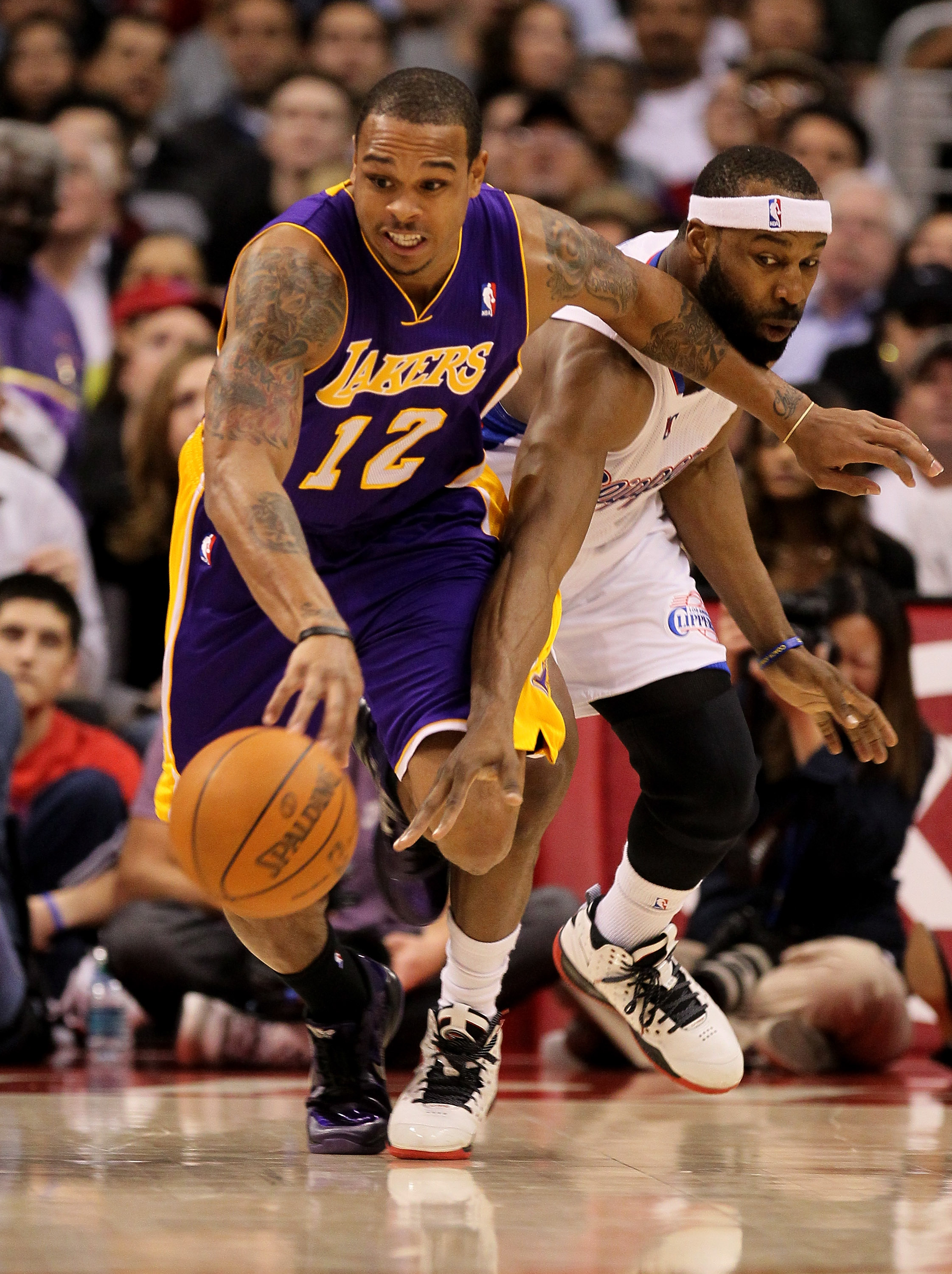 LOS ANGELES, CA - DECEMBER 8:  Shannon Brown #12 of the Los Angeles Lakers is fouled by Baron Davis #5 of the Los Angeles Clippers as he starts a break at Staples Center on December 8, 2010 in Los Angeles, California.  NOTE TO USER: User expressly acknowl
