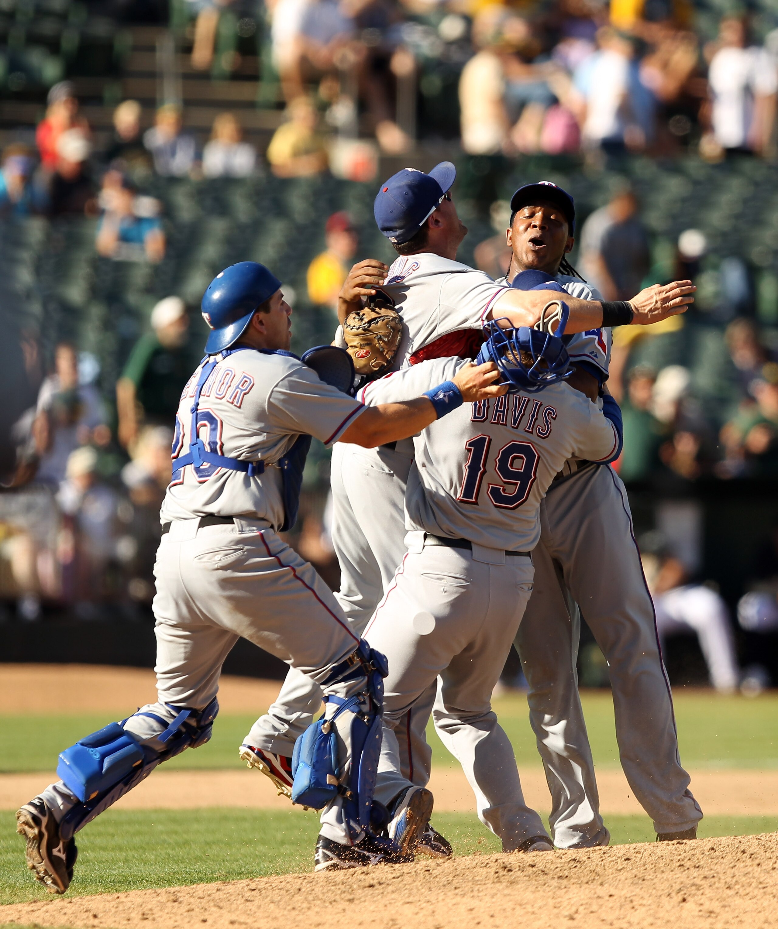 OAKLAND, CA - SEPTEMBER 25:  Michael Young #10, Chris Davis #19, Matt Treanor #20 and Neftali Feliz #30 of the Texas Rangers celebrate after they beat the Oakland Athletics to clinch the American League West Title at the Oakland-Alameda County Coliseum on
