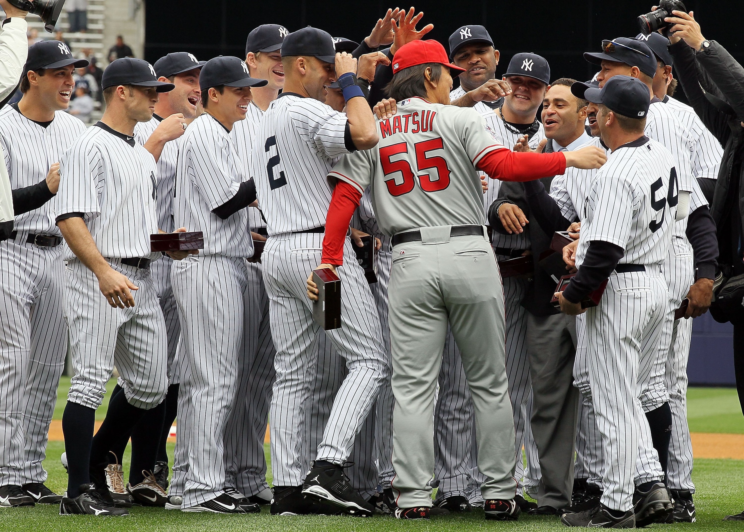 NEW YORK - APRIL 13: Hideki Matsui #55 of the Los Angeles Angels of Anaheim is greeted by former teammates of the New York Yankees after Matsui received his World Series ring for being a member of the 2009 New York Yankees Worlder Series Championship team NEW YORK - APRIL 13: Hideki Matsui #55 of the Los Angeles Angels of Anaheim is greeted by former teammates of the New York Yankees after Matsui received his World Series ring for being a member of the 2009 New York Yankees Worlder Series Championship team