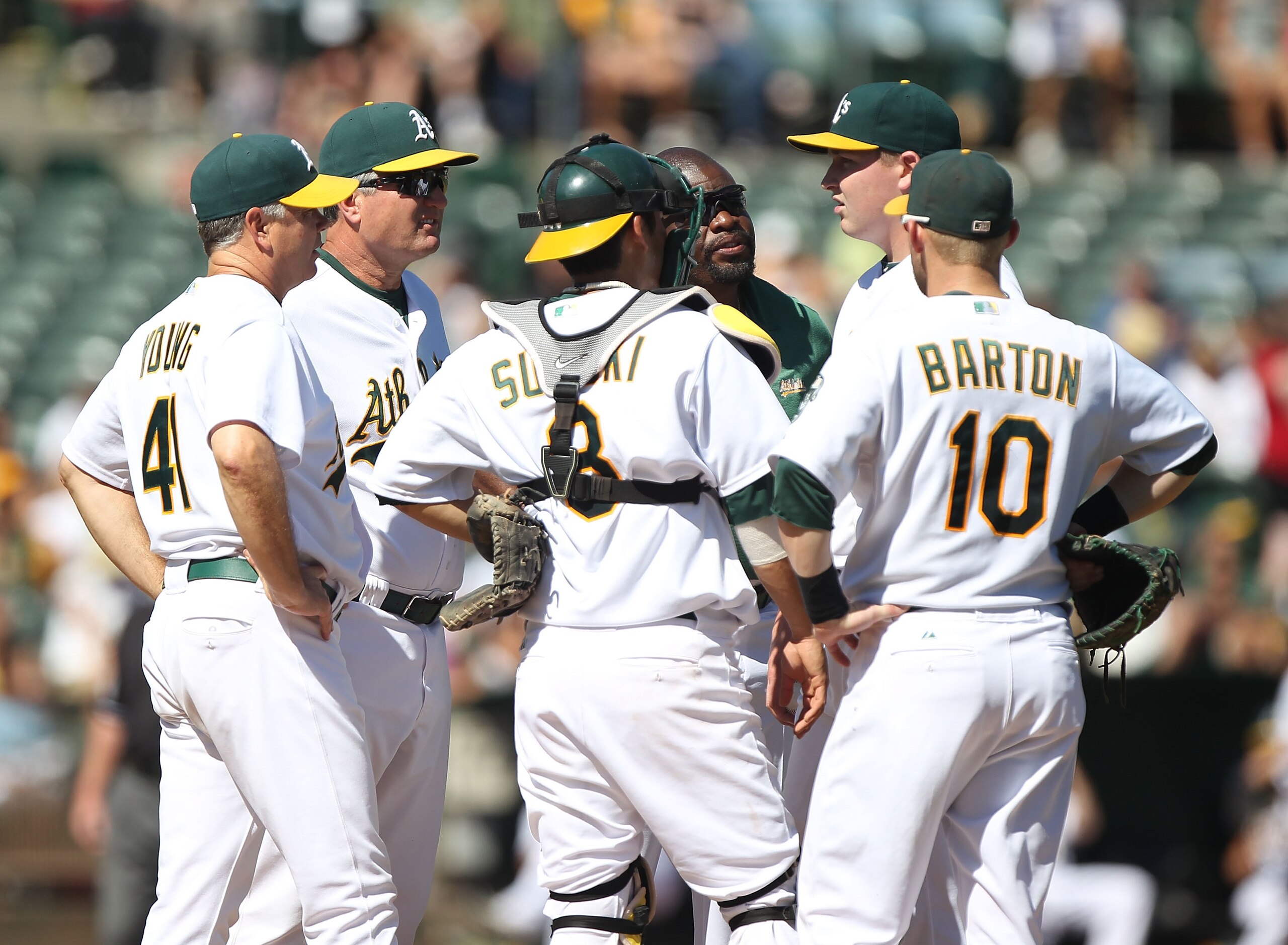 OAKLAND, CA - SEPTEMBER 26:  Trevor Cahill #53 of the Oakland Athletics talks with teammates on the mound against the Texas Rangers during a Major League Baseball game at the Oakland-Alameda County Coliseum on September 26, 2010 in Oakland, California.  (