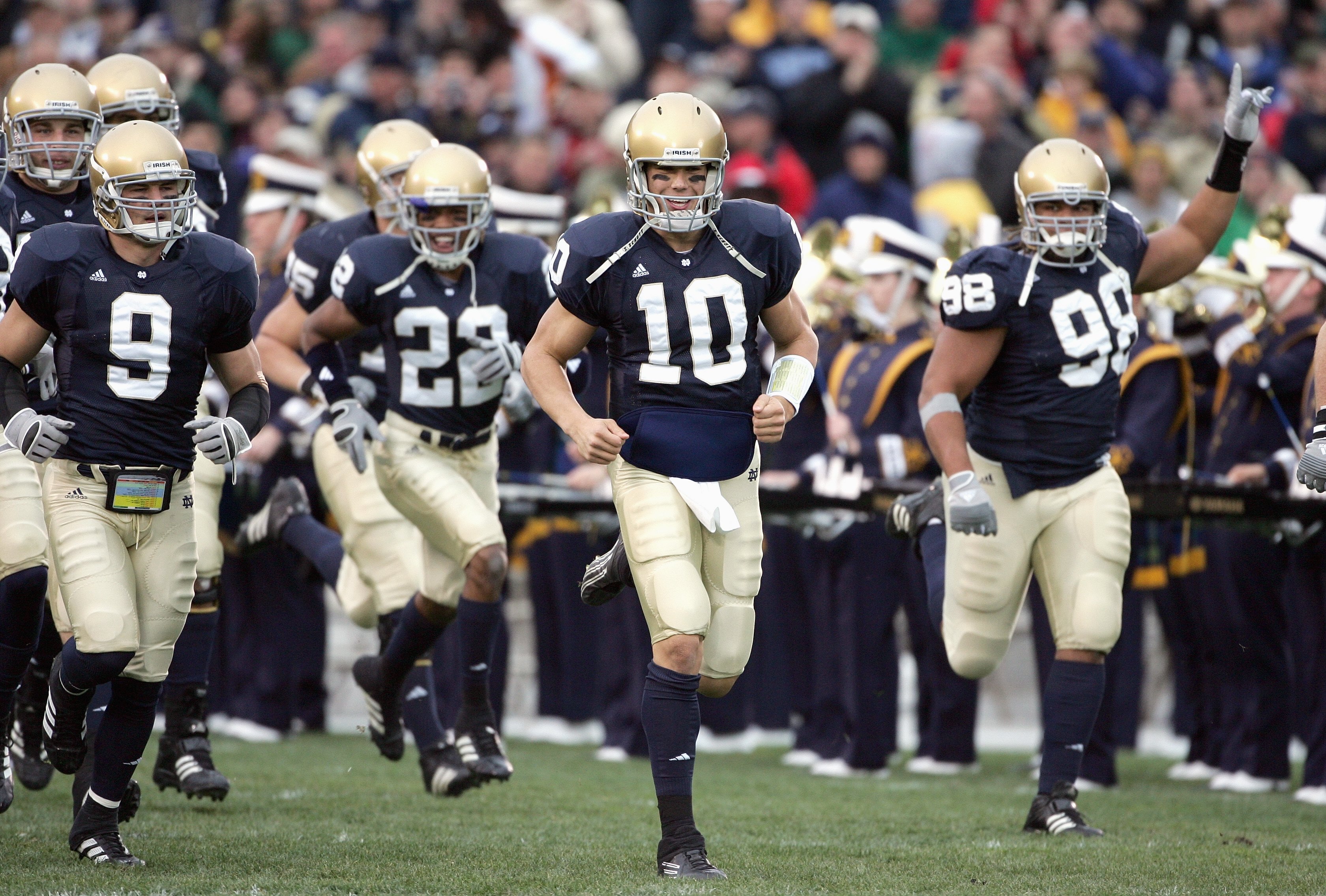 SOUTH BEND, IN - NOVEMBER 4: Quarterback Brady Quinn #10 and Tom Zbikowski #9 of the Notre Dame Fighting Irish run onto the field before the game against the North Carolina Tar Heels on November 4, 2006 at Notre Dame Stadium in South Bend, Indiana. (Photo