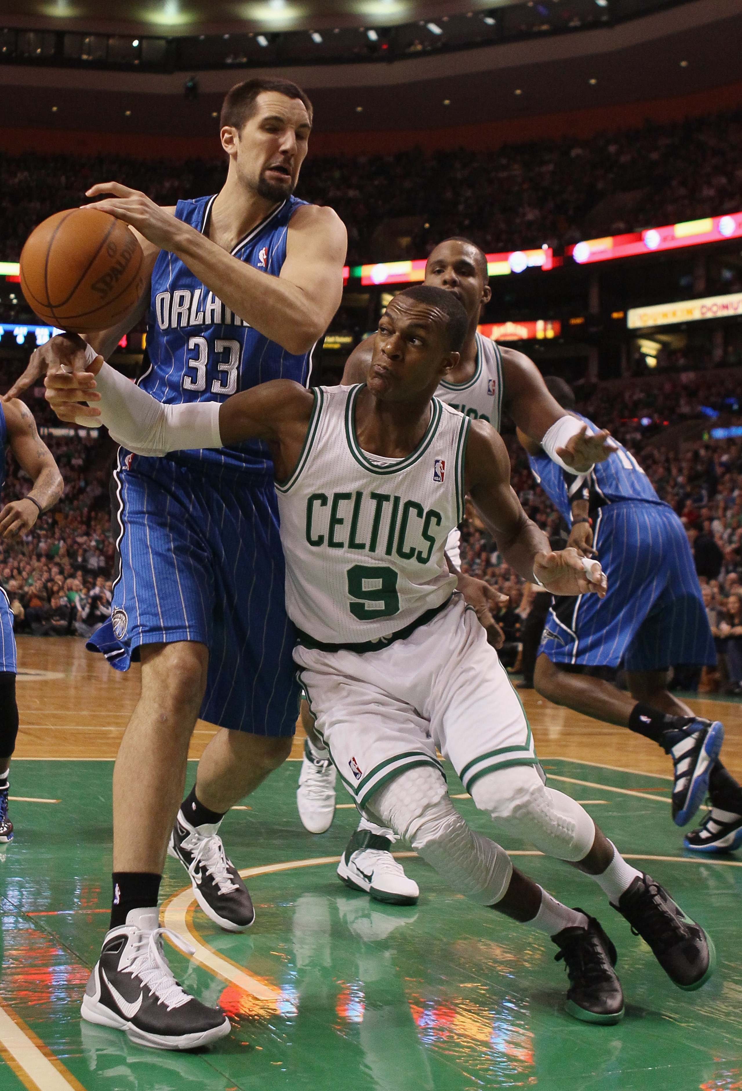 BOSTON, MA - FEBRUARY 06:  Rajon Rondo #9 of the Boston Celtics and Ryan Anderson #33 of the Orlando Magic fight for the ball on February 6, 2011 at the TD Garden in Boston, Massachusetts. The Celtics defeated the Magic 91-80. NOTE TO USER: User expressly