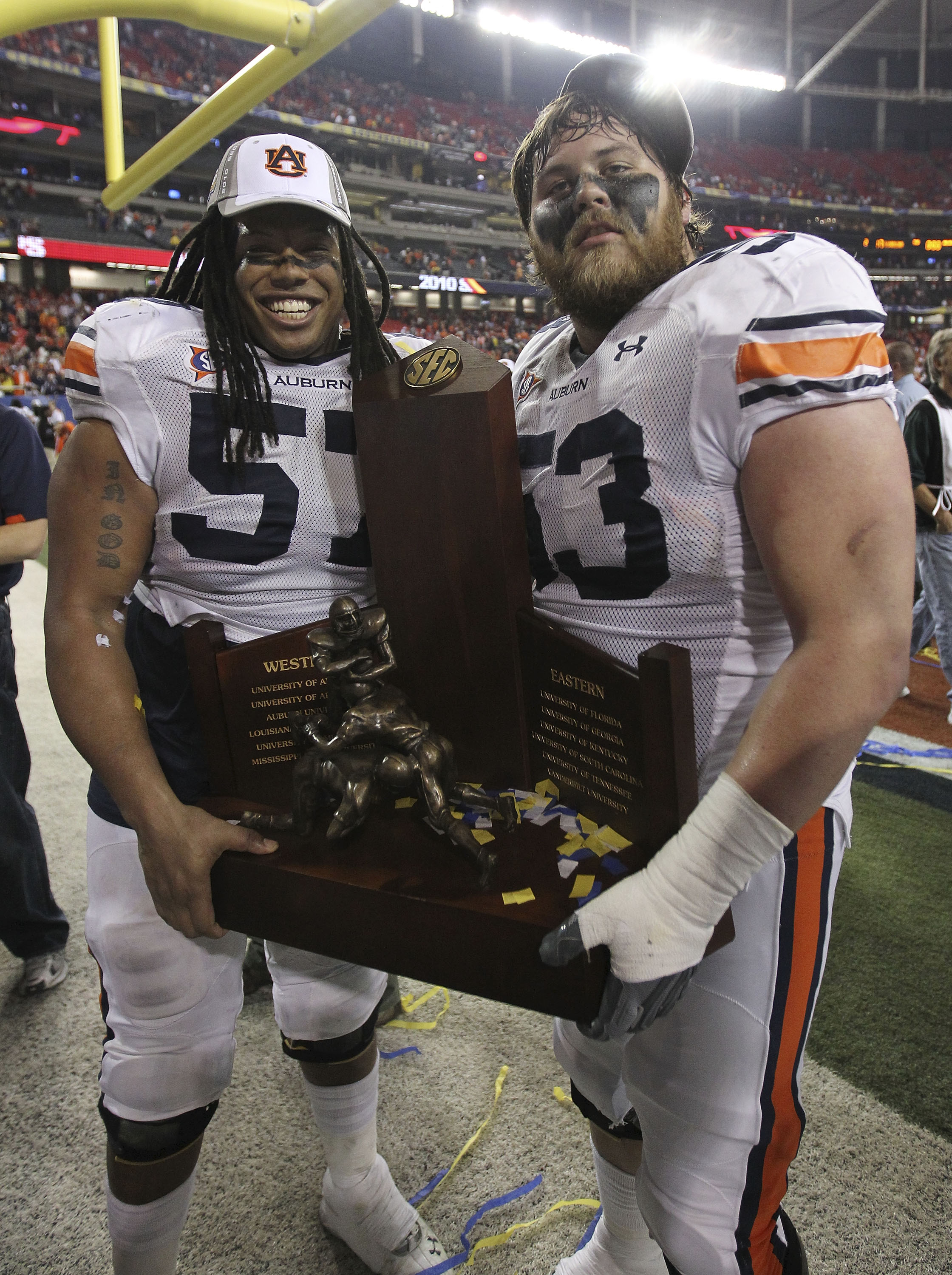 ATLANTA - DECEMBER 4: Lineman Bryon Isom #57 (left) and Bart Eddins #53 of the Auburn Tigers celebrate with the SEC Championship trophy after the 2010 SEC Championship against the South Carolina Gamecocks at Georgia Dome on December 4, 2010 in Atlanta, G ATLANTA - DECEMBER 4: Lineman Bryon Isom #57 (left) and Bart Eddins #53 of the Auburn Tigers celebrate with the SEC Championship trophy after the 2010 SEC Championship against the South Carolina Gamecocks at Georgia Dome on December 4, 2010 in Atlanta, G
