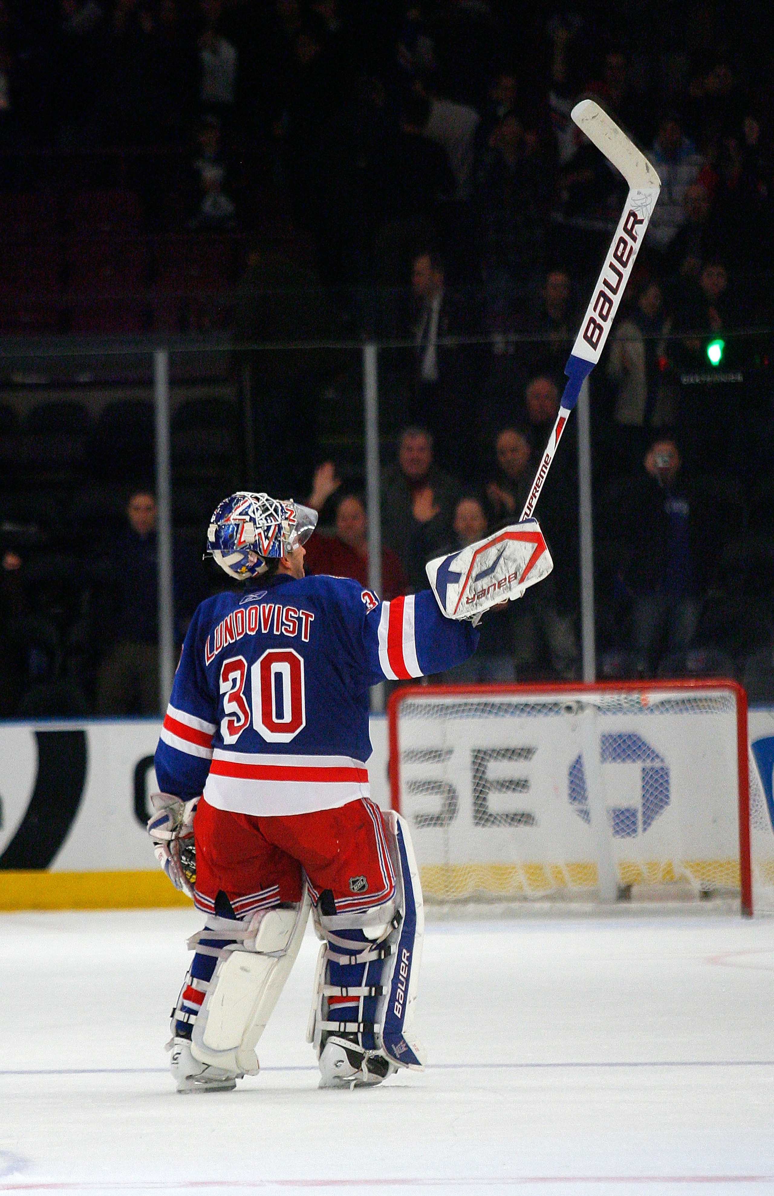 NEW YORK , NY - JANUARY 13: Winning goaltender Henrik Lundqvist #30 of the New York Rangers salutes the fans after being named the first star of the game after shuting out the Vancouver Canucks at Madison Square Garden on January 13, 2011 in New York City