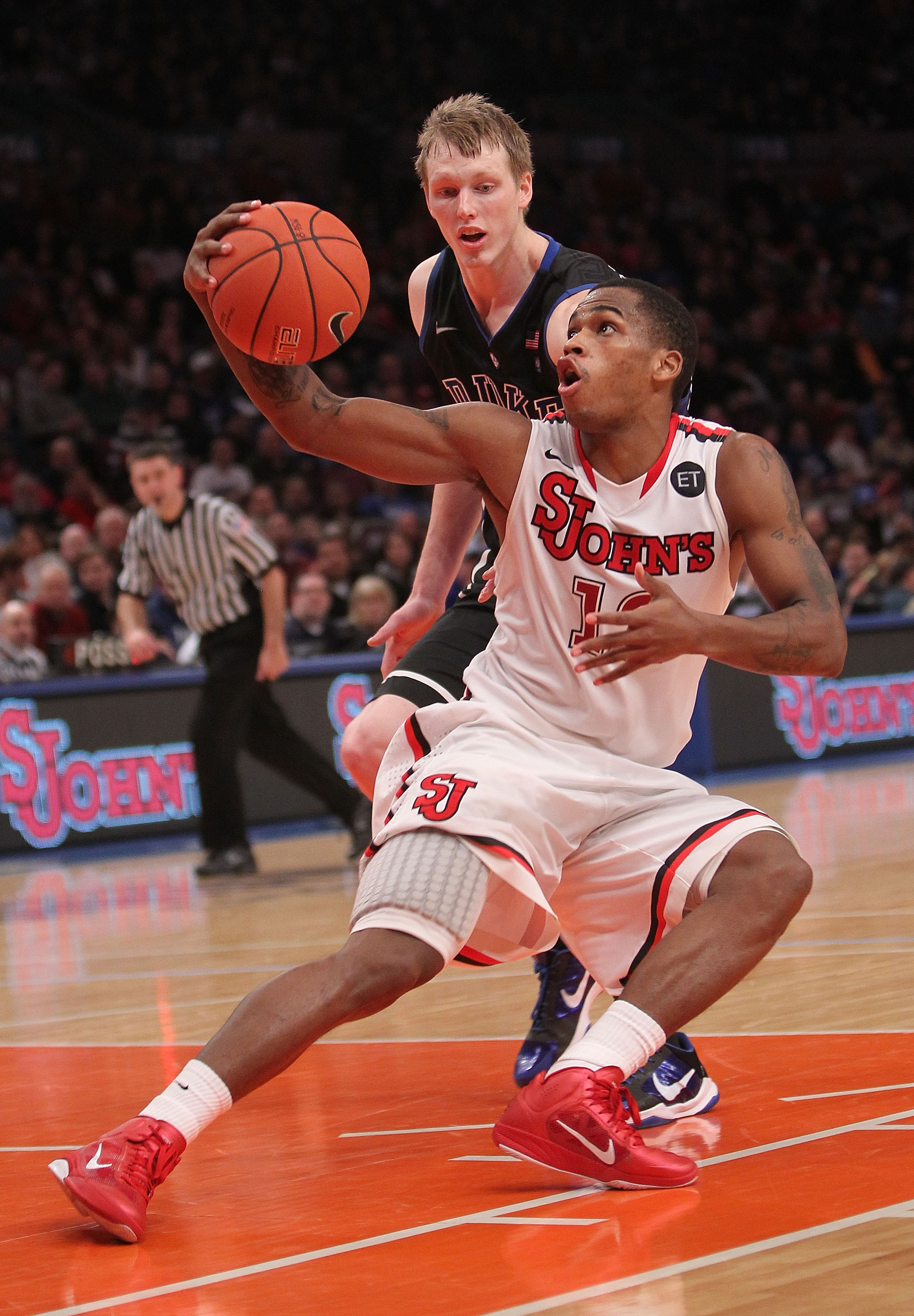 NEW YORK, NY - JANUARY 30: Dwight Hardy #12 of the St. John's Red Storm fakes in front of Kyle Singler #12 of the Duke Blue Devils  at Madison Square Garden on January 30, 2011 in New York City.  (Photo by Nick Laham/Getty Images)