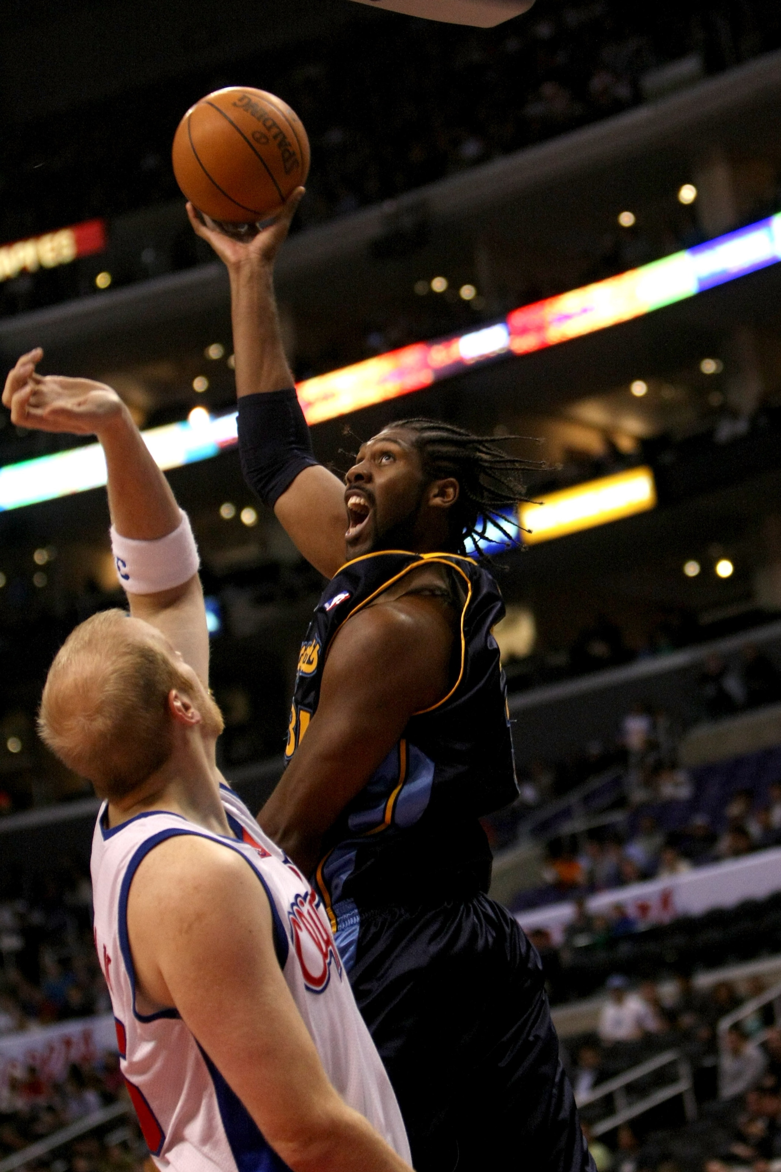 LOS ANGELES, CA - NOVEMBER 20: Nene #31 of the Denver Nuggets shoots over Chris Kaman #35 of the Los Angeles Clippers on November 20, 2009 at Staples Center in Los Angeles, California. NOTE TO USER: User expressly acknowledges and agrees that, by dow LOS ANGELES, CA - NOVEMBER 20: Nene #31 of the Denver Nuggets shoots over Chris Kaman #35 of the Los Angeles Clippers on November 20, 2009 at Staples Center in Los Angeles, California. NOTE TO USER: User expressly acknowledges and agrees that, by dow