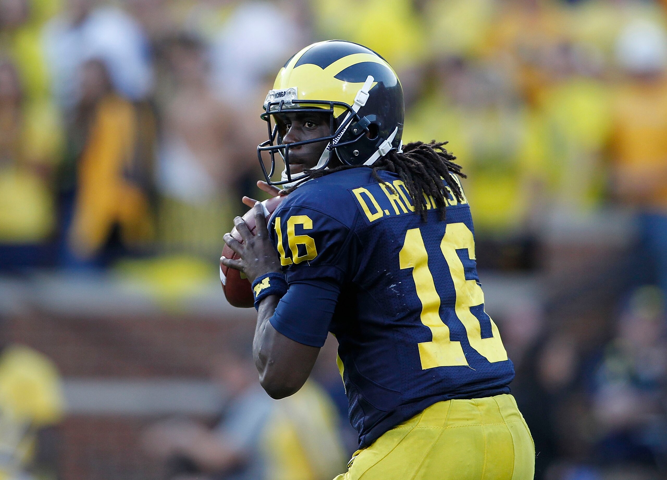 ANN ARBOR, MI - OCTOBER 09: Denard Robinson #16 of the Michigan Wolverines drops back to pass during the game against the Michigan State Spartans on October 9, 2010 at Michigan Stadium in Ann Arbor, Michigan. The Michigan State Spartans defeated the Mich ANN ARBOR, MI - OCTOBER 09: Denard Robinson #16 of the Michigan Wolverines drops back to pass during the game against the Michigan State Spartans on October 9, 2010 at Michigan Stadium in Ann Arbor, Michigan. The Michigan State Spartans defeated the Mich