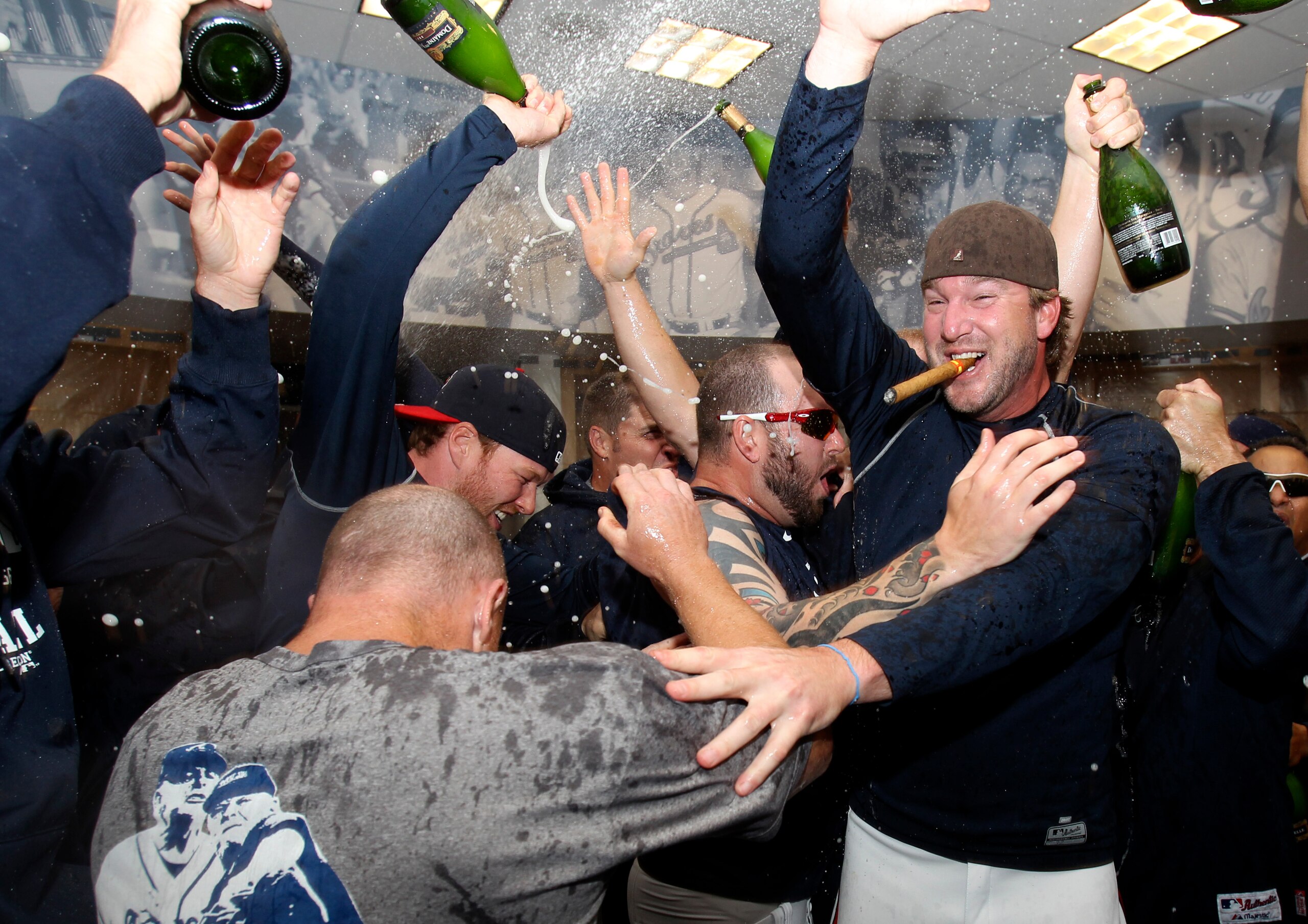 ATLANTA - OCTOBER 03:  Pitcher Derek Lowe #32 of the Atlanta Braves (right)celebrates with teammates after the Braves clinch the National League Wildcard after the game against the Philadelphia Phillies at Turner Field on October 3, 2010 in Atlanta, Georg