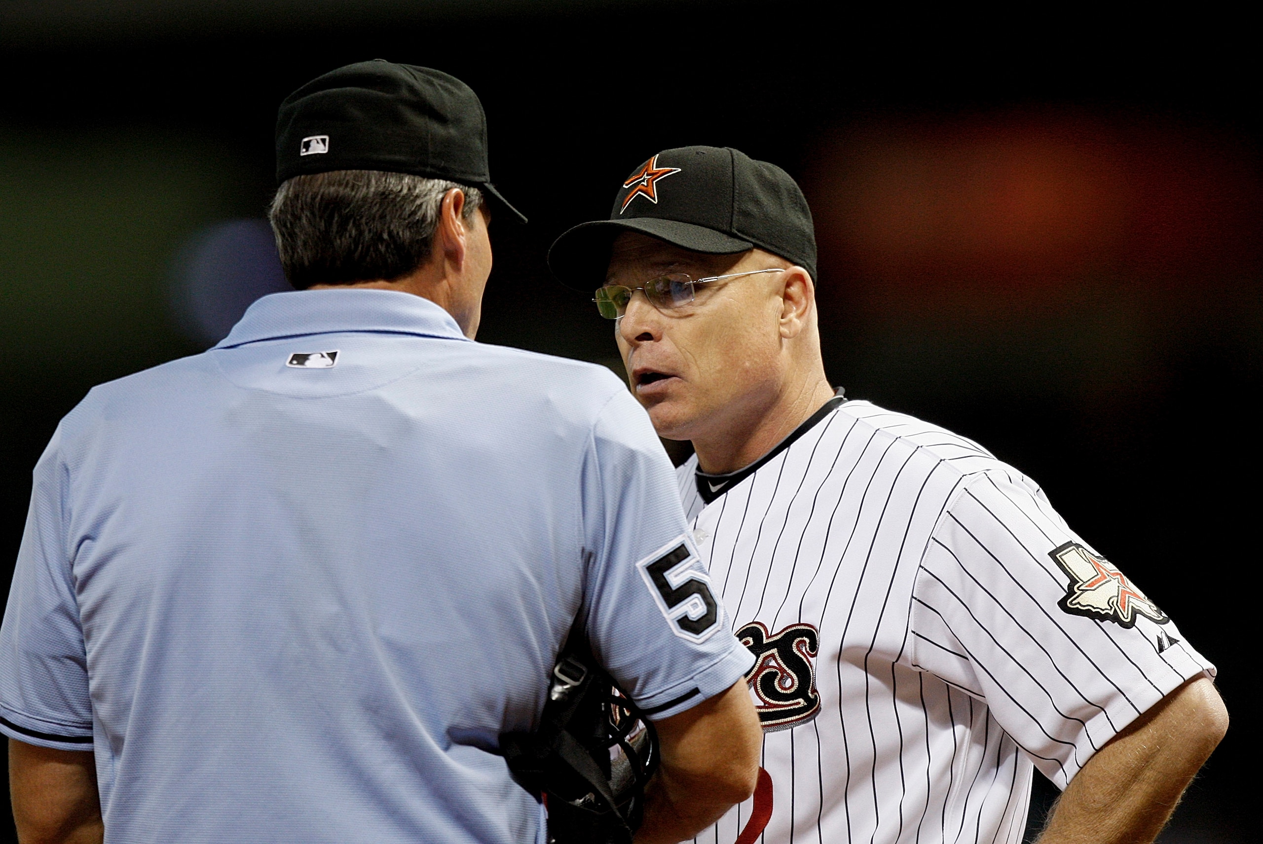 HOUSTON - AUGUST 19: Houston Astros manager Brad Mills #2 argues with home plate umpire Angel Hernandez after David Wright was struck by a pitch in the fourth inning at Minute Maid Park on August 19, 2010 in Houston, Texas. Mills argued that Wrigh had sw HOUSTON - AUGUST 19: Houston Astros manager Brad Mills #2 argues with home plate umpire Angel Hernandez after David Wright was struck by a pitch in the fourth inning at Minute Maid Park on August 19, 2010 in Houston, Texas. Mills argued that Wrigh had sw