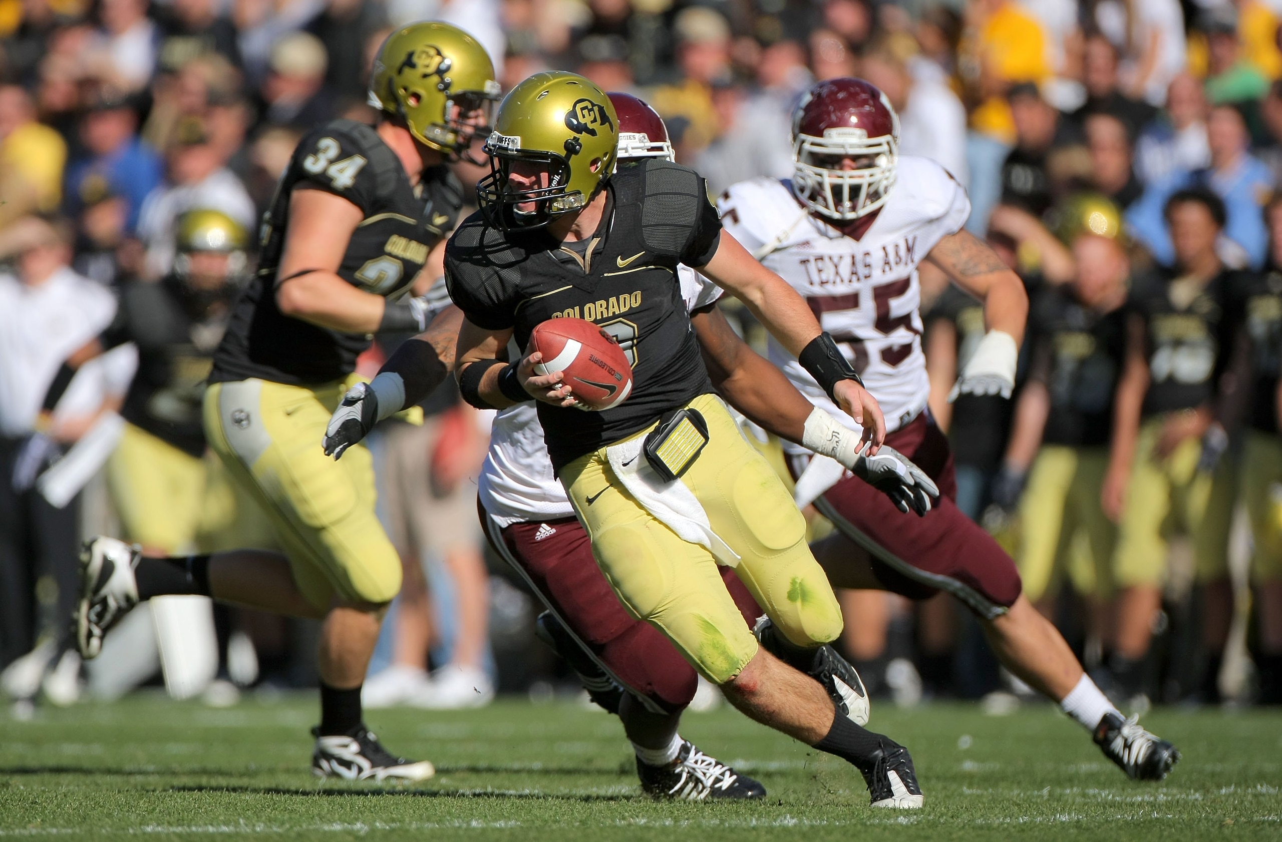 BOULDER, CO - NOVEMBER 07:  Quarterback Tyler Hansen #9 of the Colorado Buffaloes rolls out to deliver a pass against the Texas A&M Aggies during NCAA college football action at Folsom Field on November 7, 2009 in Boulder, Colorado. Colorado defeated Texa