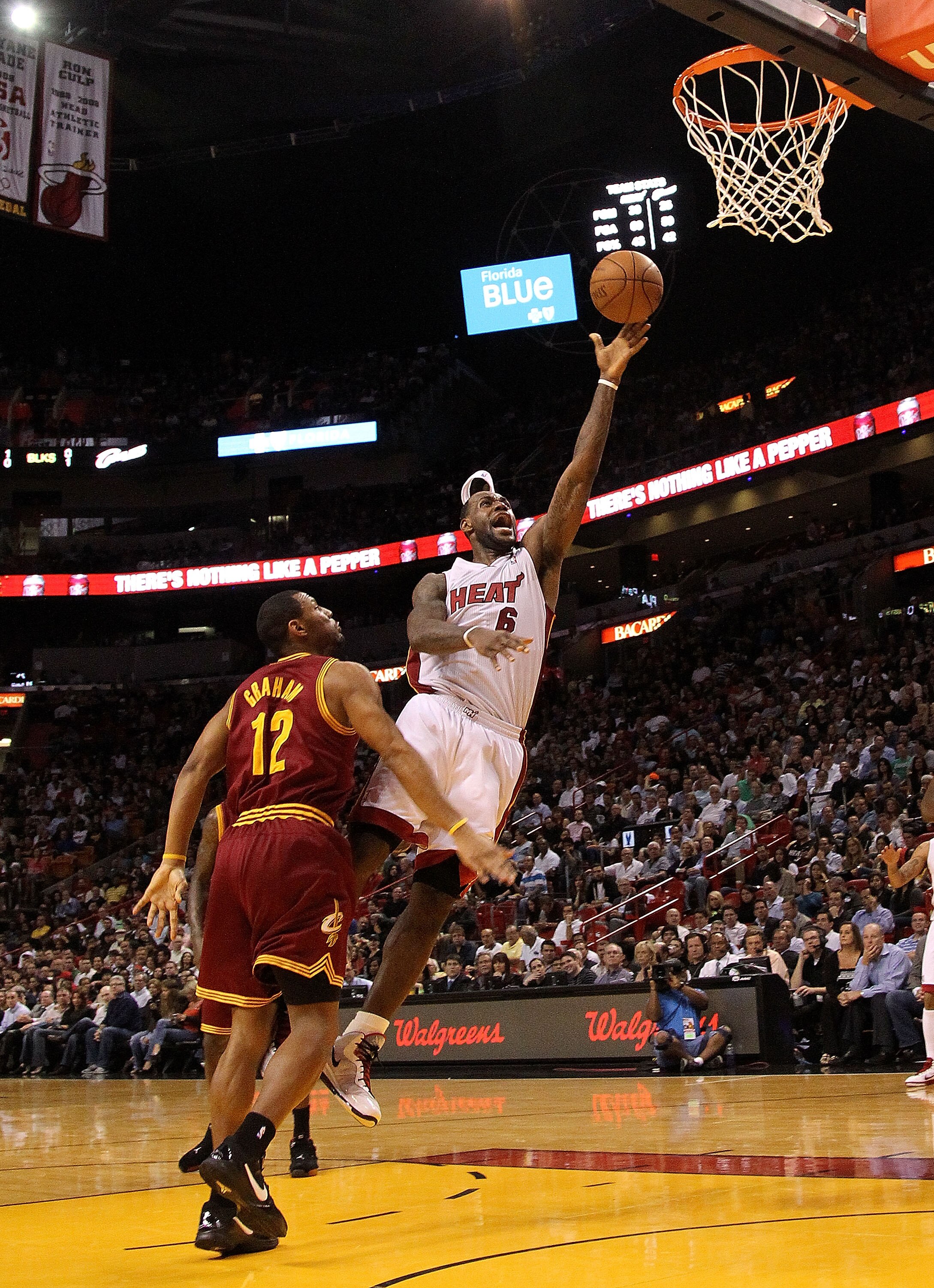 MIAMI, FL - JANUARY 31:  LeBron James #6 of the Miami Heat takes a shot against Joey Graham #12 of the Cleveland Cavaliers during a game at American Airlines Arena on January 31, 2011 in Miami, Florida. NOTE TO USER: User expressly acknowledges and agrees