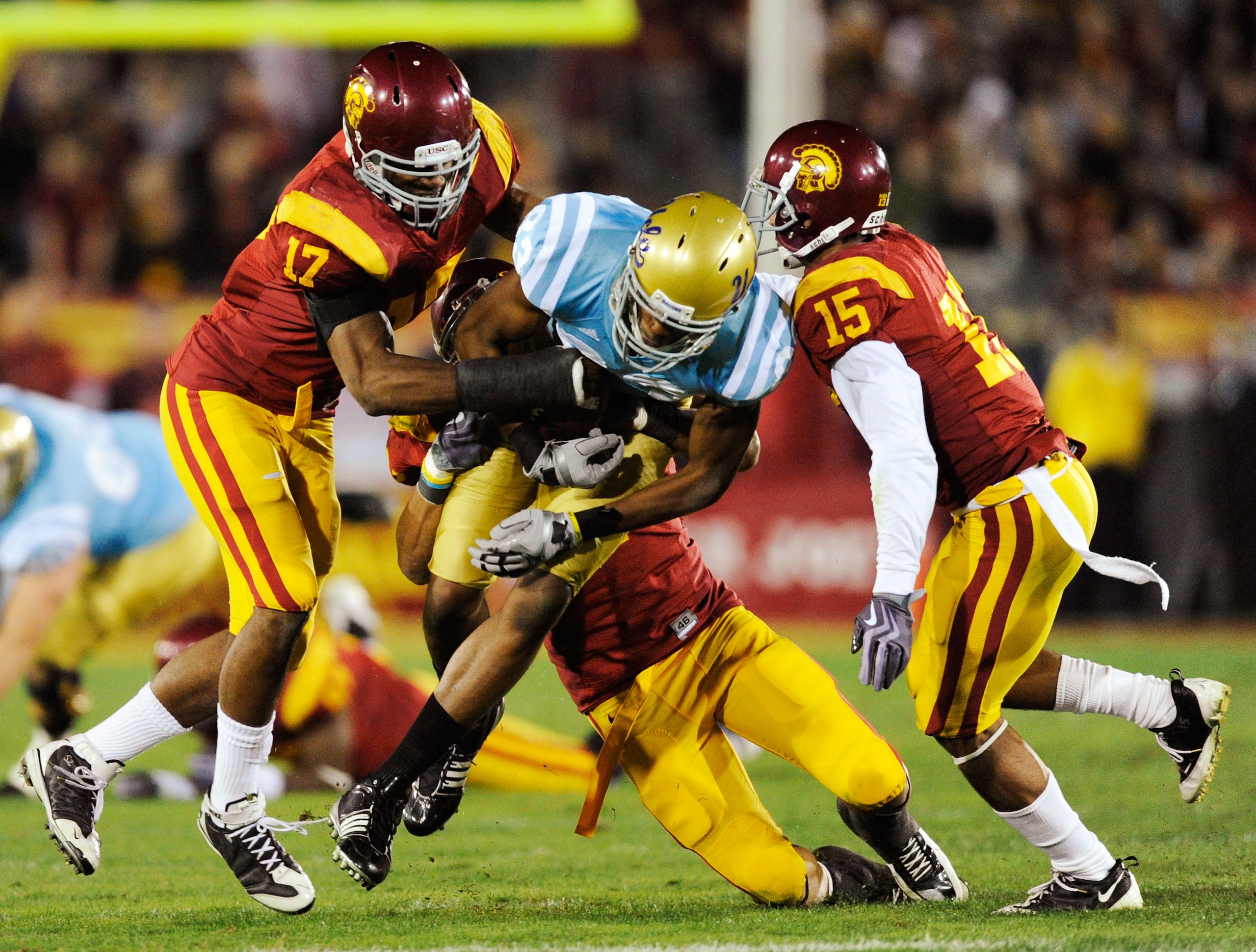 LOS ANGELES, CA - NOVEMBER 28: Nelson Rosario #83 of the UCLA Bruins is surrounded by USC Trojans defenders after catching a pass during the second quarter of the NCAA college football game at Los Angeles Memorial Coliseum on November 28, 2009 in Los Ang LOS ANGELES, CA - NOVEMBER 28: Nelson Rosario #83 of the UCLA Bruins is surrounded by USC Trojans defenders after catching a pass during the second quarter of the NCAA college football game at Los Angeles Memorial Coliseum on November 28, 2009 in Los Ang