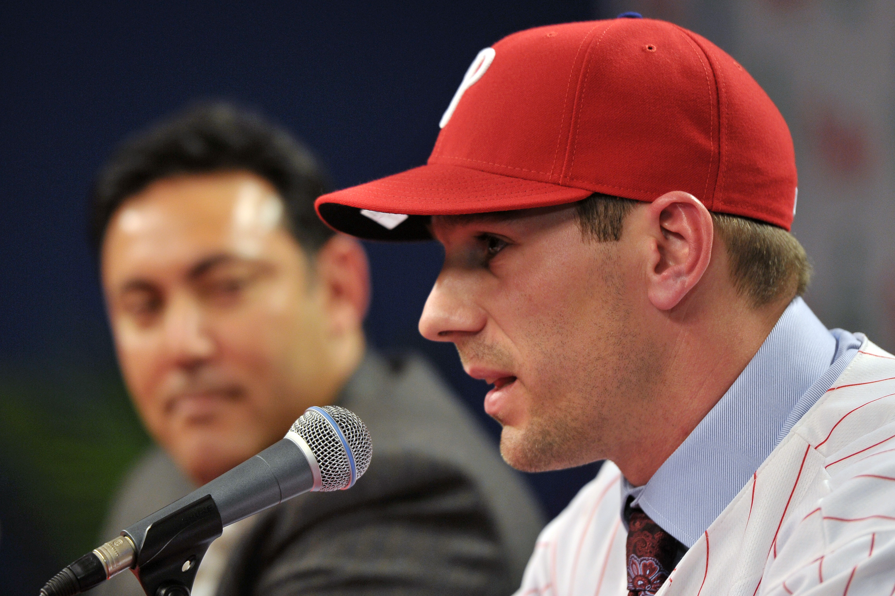 PHILADELPHIA - DECEMBER 15: Pitcher Cliff Lee #33 of the Philadelphia Phillies talks with the media while general manager Ruben Amaro Jr. watches during a press conference at Citizens Bank Park on December 15, 2010 in Philadelphia, Pennsylvania. (Photo by