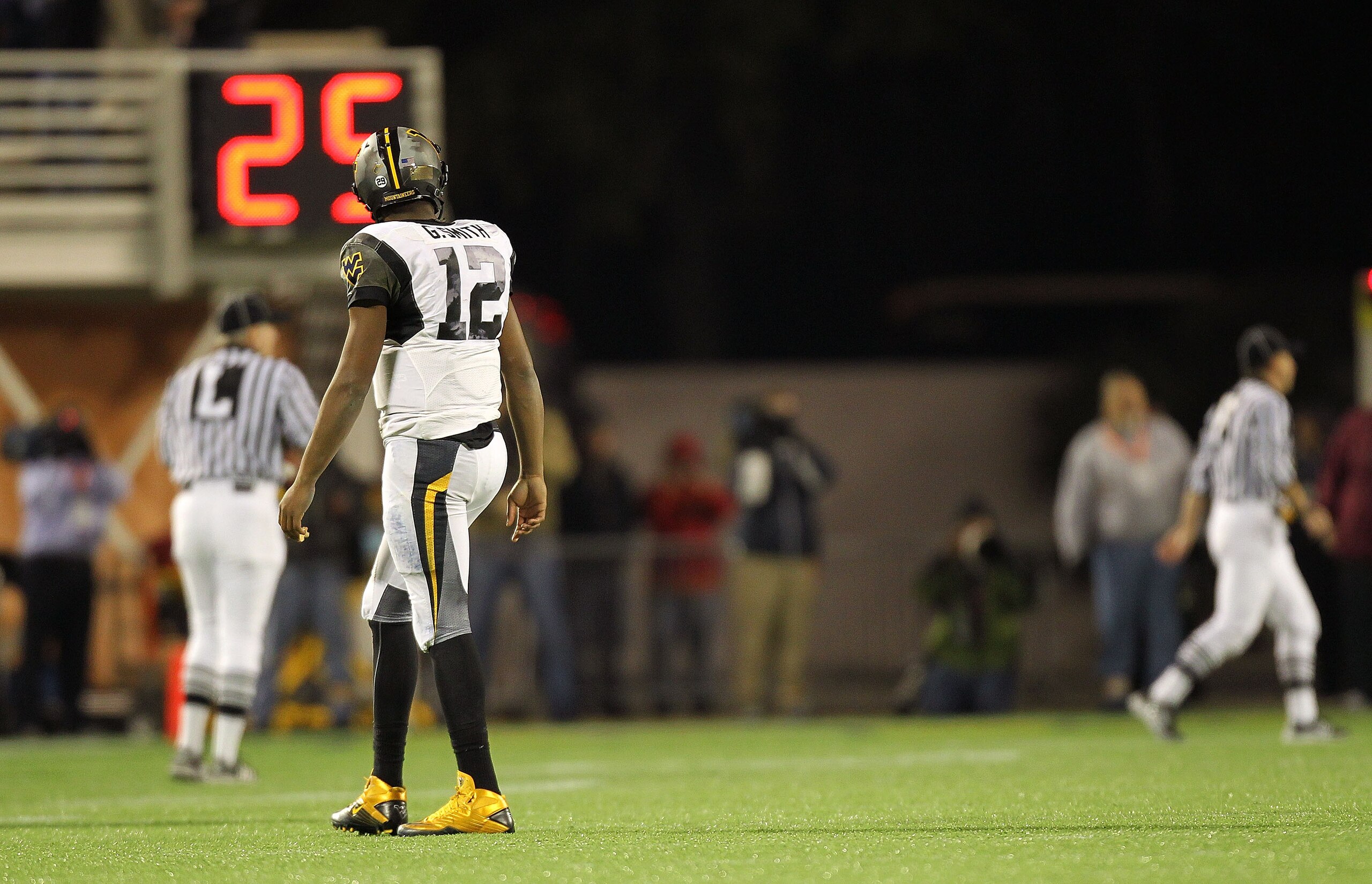 ORLANDO, FL - DECEMBER 28:  Geno Smith #12 of the West Virginia Mountineers walks off the field after an interception during the Champs Sports Bowl against the North Carolina State Wolfpack at Florida Citrus Bowl Stadium on December 28, 2010 in Orlando, F