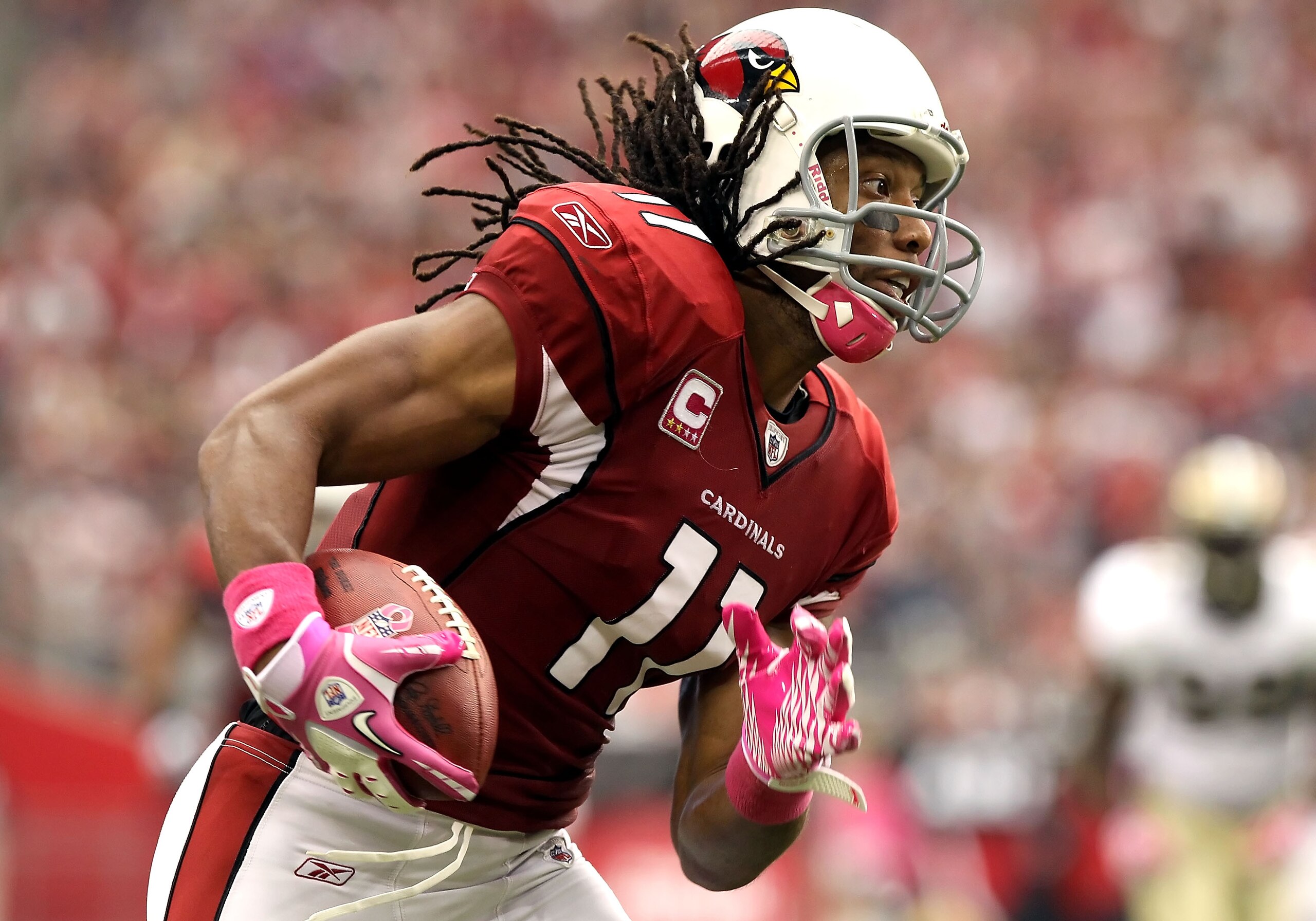 GLENDALE, AZ - OCTOBER 10: Wide receiver Larry Fitzgerald #11 of the Arizona Cardinals runs with the football after a reception against the New Orleans Saints during the NFL game at the University of Phoenix Stadium on October 10, 2010 in Glendale, Arizo GLENDALE, AZ - OCTOBER 10: Wide receiver Larry Fitzgerald #11 of the Arizona Cardinals runs with the football after a reception against the New Orleans Saints during the NFL game at the University of Phoenix Stadium on October 10, 2010 in Glendale, Arizo