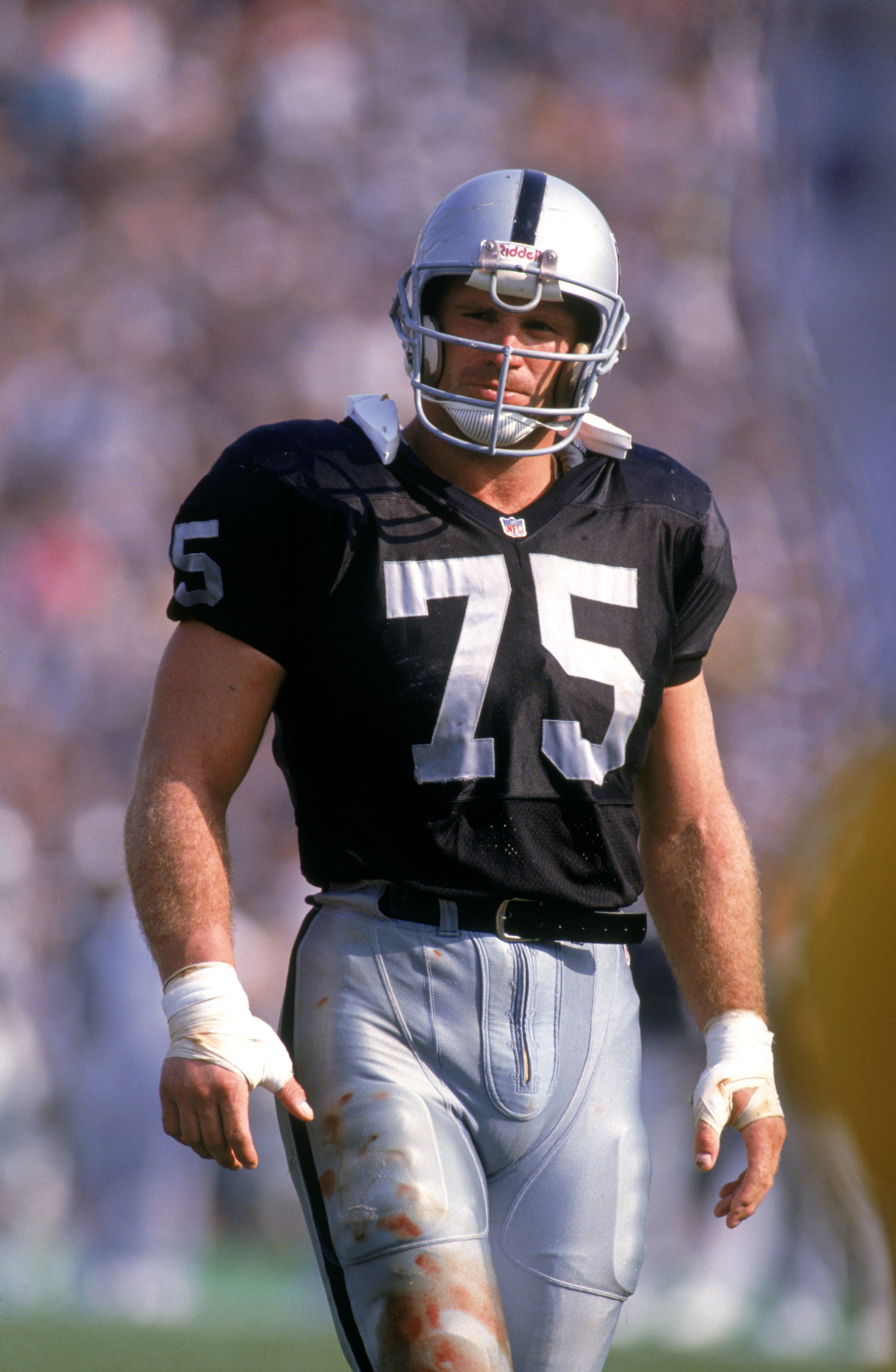 LOS ANGELES - 1991:  Defensive lineman Howie Long #75 of the Los Angeles Raiders looks on during a 1991 NFL season game at Los Angeles Memorial Coliseum in Los Angeles, California.  (Photo by Stephen Dunn/Getty Images)