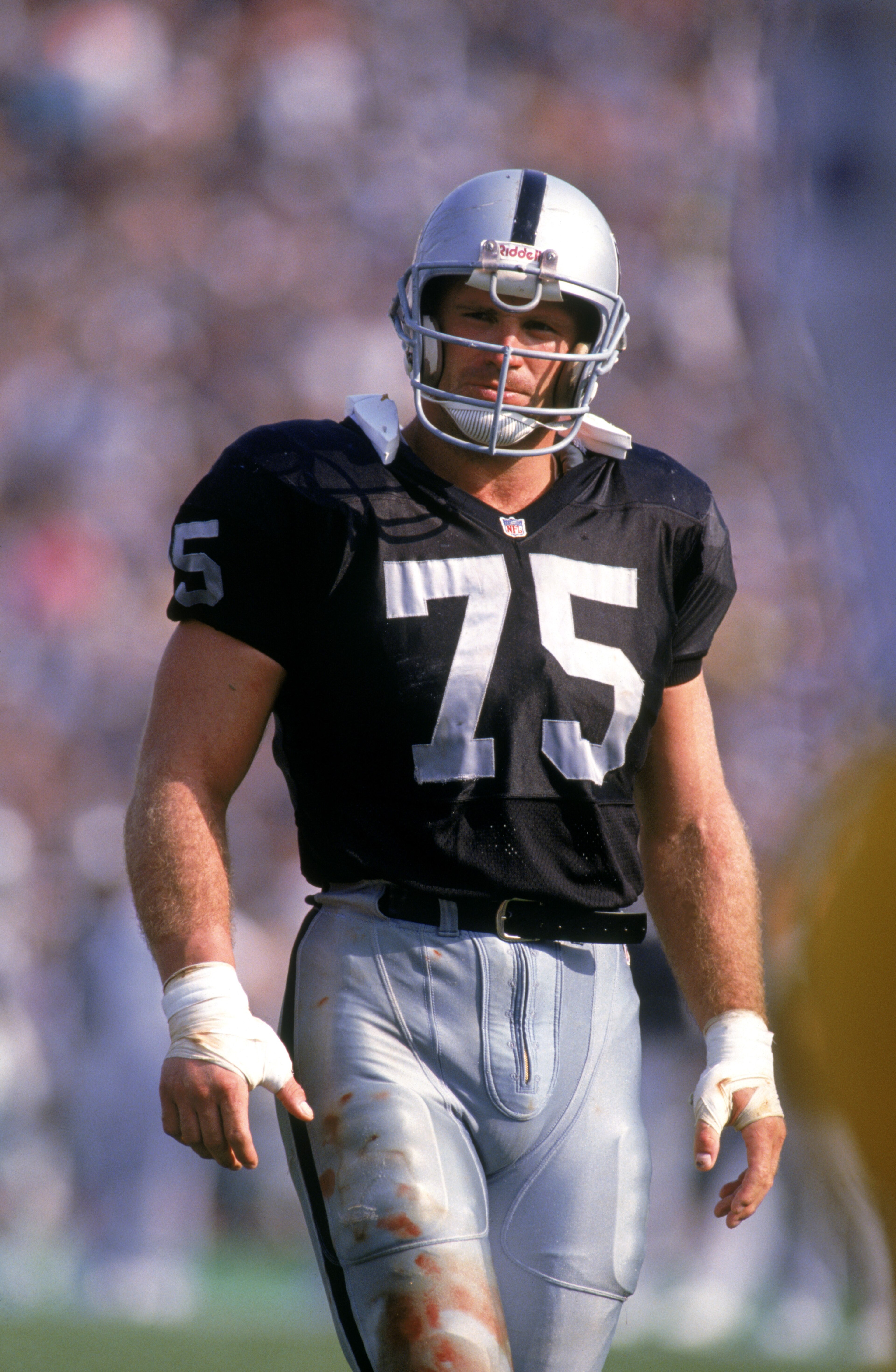 LOS ANGELES - 1991:  Defensive lineman Howie Long #75 of the Los Angeles Raiders looks on during a 1991 NFL season game at Los Angeles Memorial Coliseum in Los Angeles, California.  (Photo by Stephen Dunn/Getty Images)
