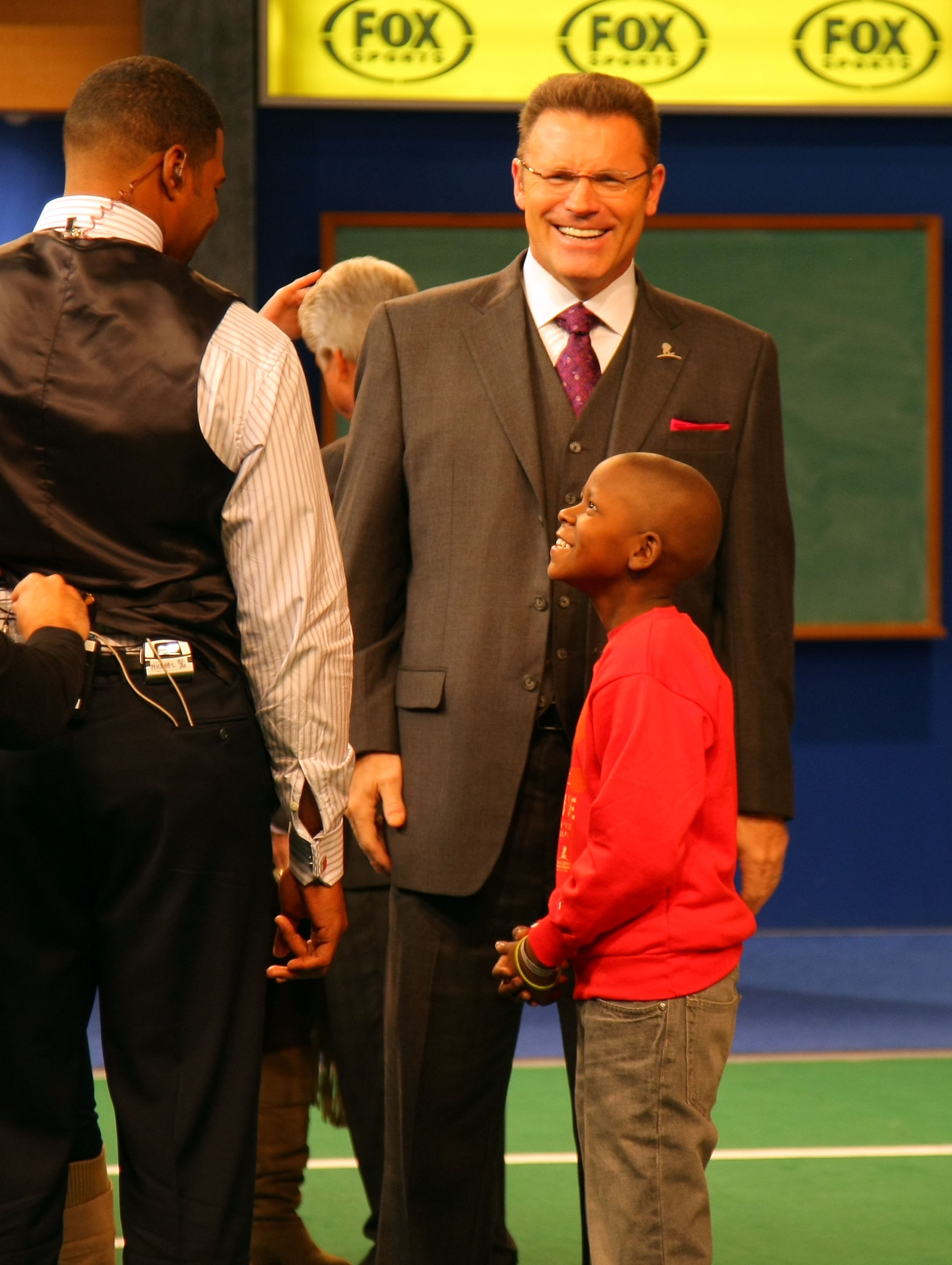 LOS ANGELES, CA - DECEMBER 12:  FOX NFL Sunday analysts Michael Strahan and Howie Long share a laugh with St. Jude Children's Research Hospital patient Markell during a break on the set of FOX NFL Sunday on December 12, 2010 in Los Angeles, United States.