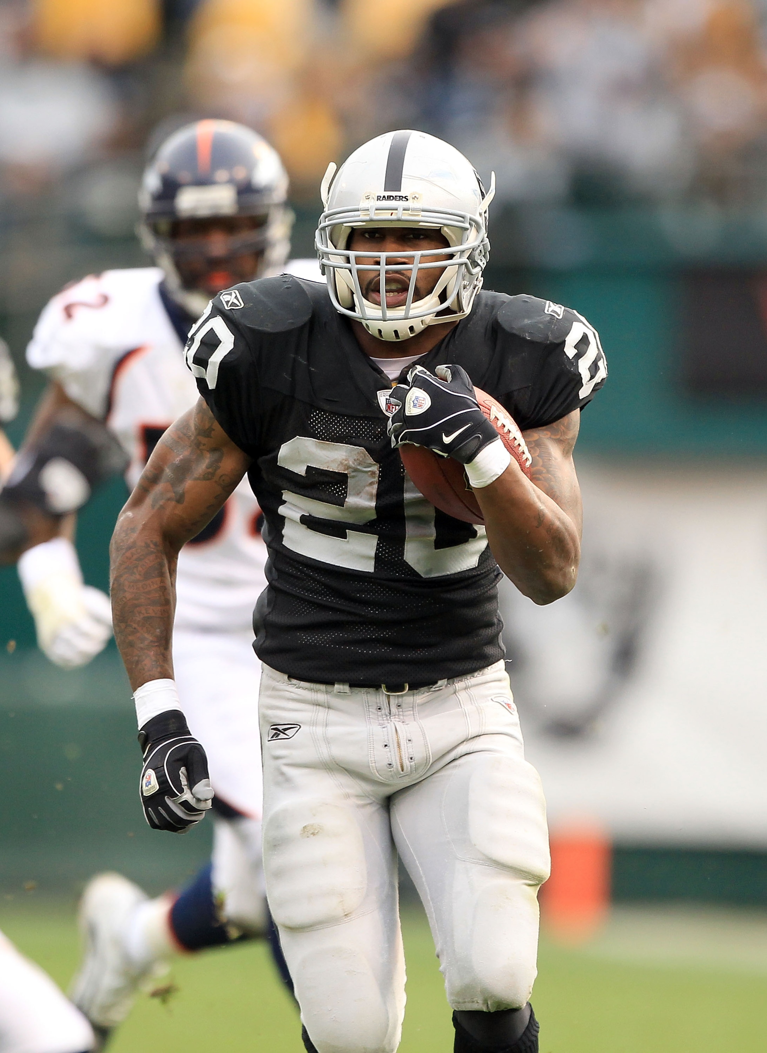 OAKLAND, CA - DECEMBER 19:  Darren McFadden #20 of the Oakland Raiders runs with the ball during their game against the Denver Broncos at Oakland-Alameda County Coliseum on December 19, 2010 in Oakland, California.  (Photo by Ezra Shaw/Getty Images)