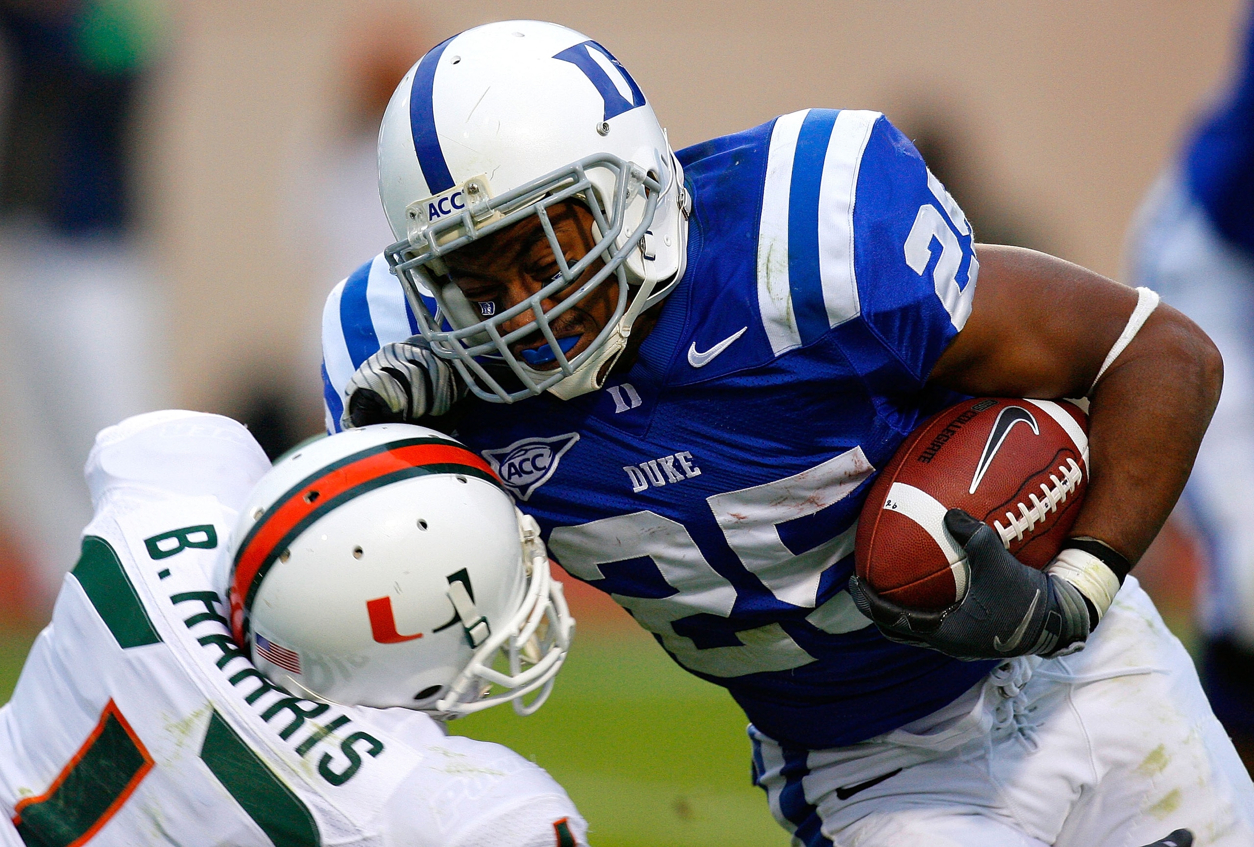 DURHAM, NC - OCTOBER 18:  Running back Tony Jackson #25 of the Duke Blue Devils stiff arms Brandon Harris #1 of the Miami Hurricanes during the game at Wallace Wade Stadium on October 18, 2008 in Durham, North Carolina.  (Photo by Kevin C. Cox/Getty Image