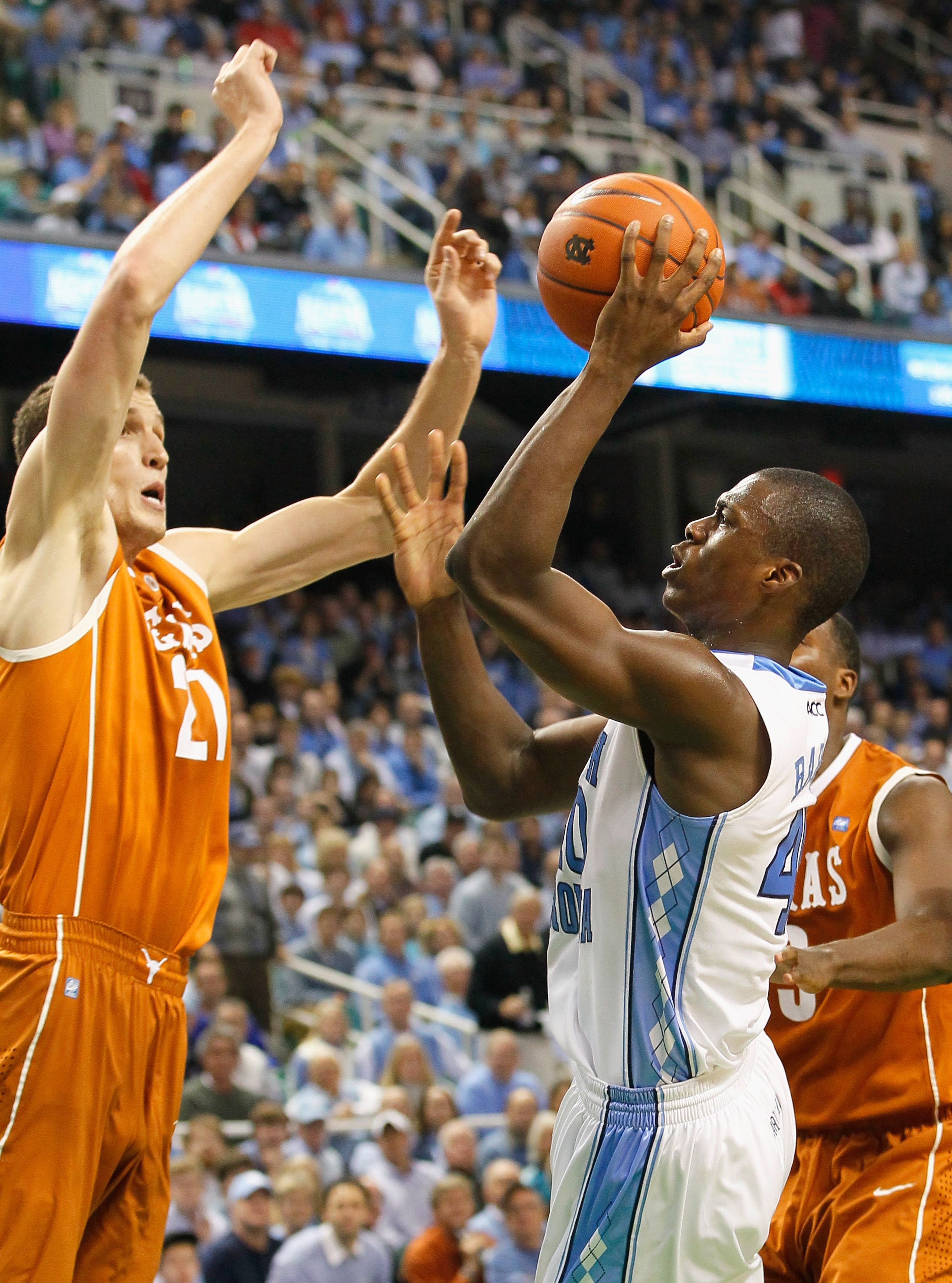 GREENSBORO, NC - DECEMBER 18:  Harrison Barnes #40 of the North Carolina Tar Heels shoots against Matt Hill #21 of the Texas Longhorns at Greensboro Coliseum on December 18, 2010 in Greensboro, North Carolina.  (Photo by Kevin C. Cox/Getty Images)