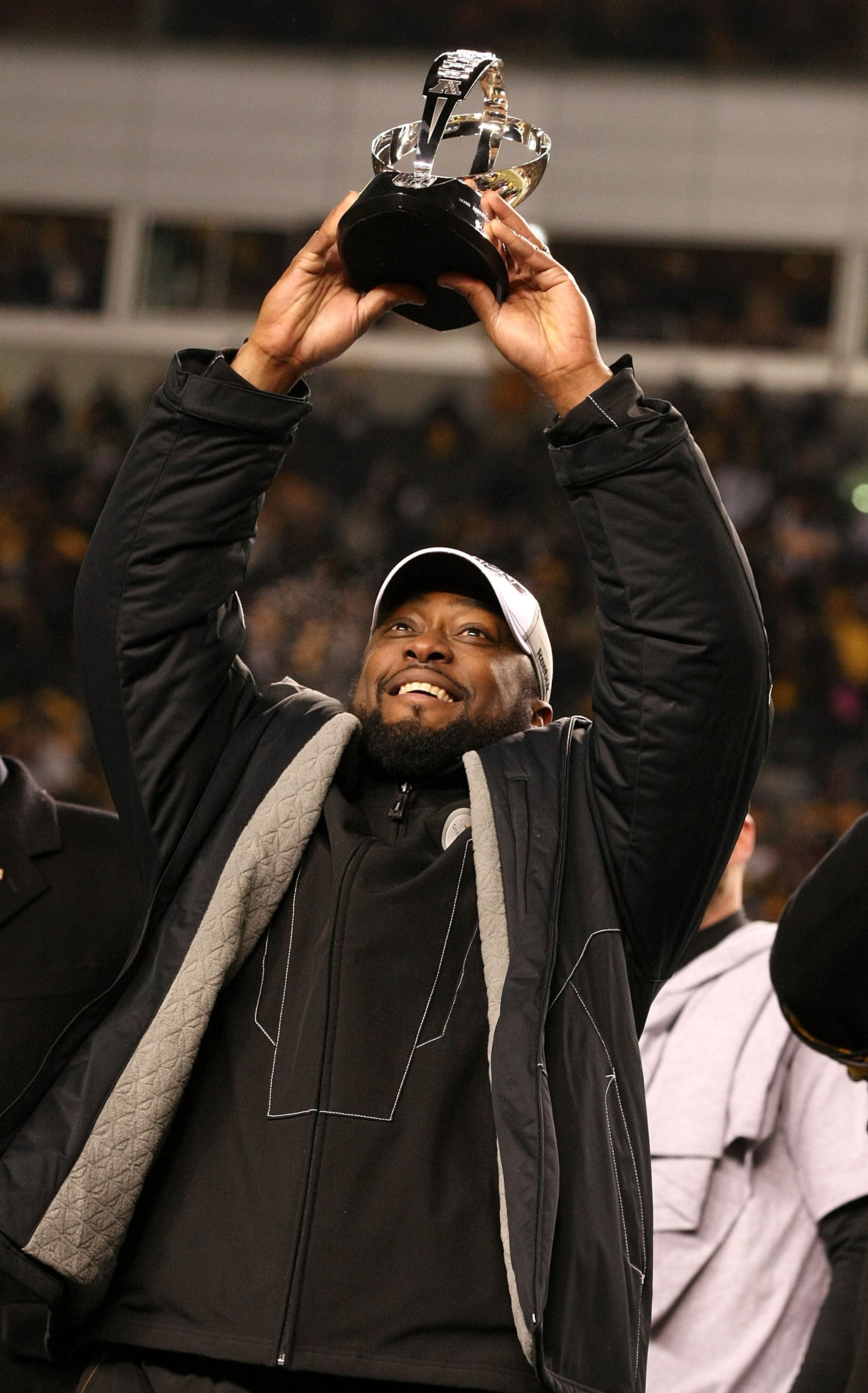 PITTSBURGH, PA - JANUARY 23:  Head coach Mike Tomlin of the Pittsburgh Steelers holds up the Lamar Hunt trophy after the Steelers defeated the New York Jets 24 to 19 in the 2011 AFC Championship game at Heinz Field on January 23, 2011 in Pittsburgh, Penns