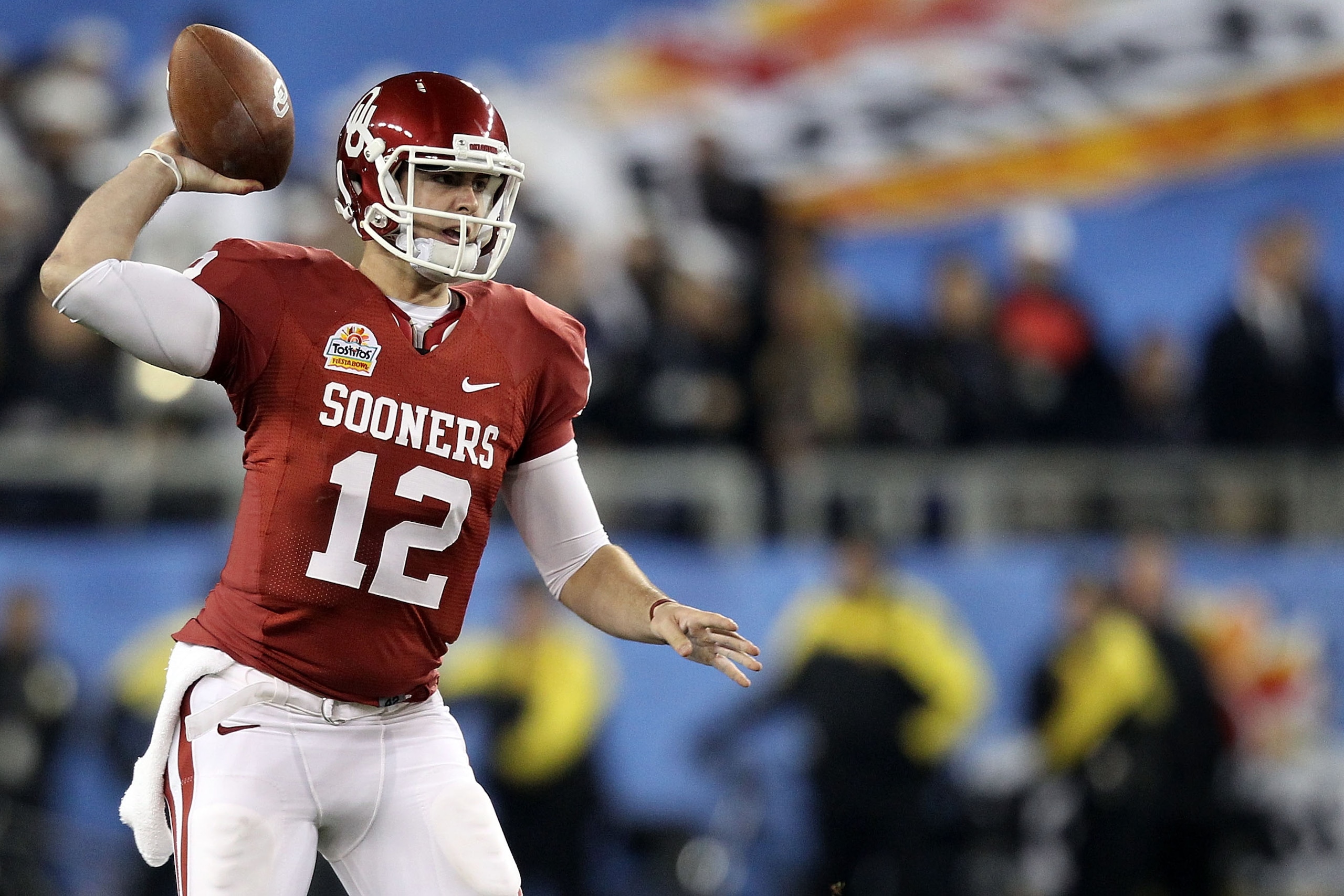 GLENDALE, AZ - JANUARY 01:  Landry Jones #12 of the Oklahoma Sooners throws the ball against the Connecticut Huskies during the Tostitos Fiesta Bowl at the Universtity of Phoenix Stadium on January 1, 2011 in Glendale, Arizona.  (Photo by Christian Peters