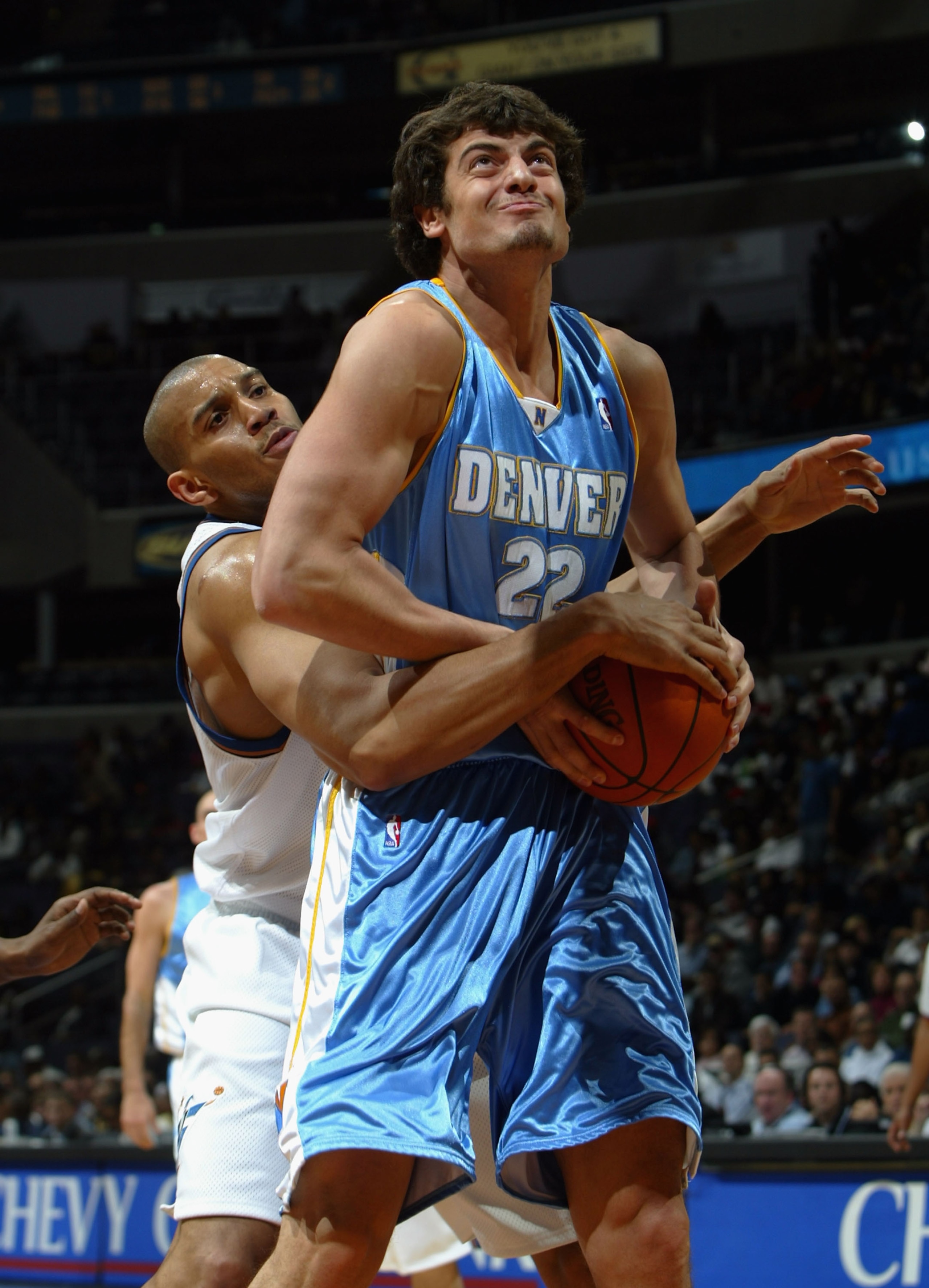 WASHINGTON DC - MARCH 9:  Nikoloz Tskitishvili #22 of the Denver Nuggets is fouled by Lonny Baxter #35 of the Washington Wizards as the Nuggets defeated the Wizards 117-87 during NBA action on March 9, 2004 at the MCI Center in Washington D.C.  (Photo by 