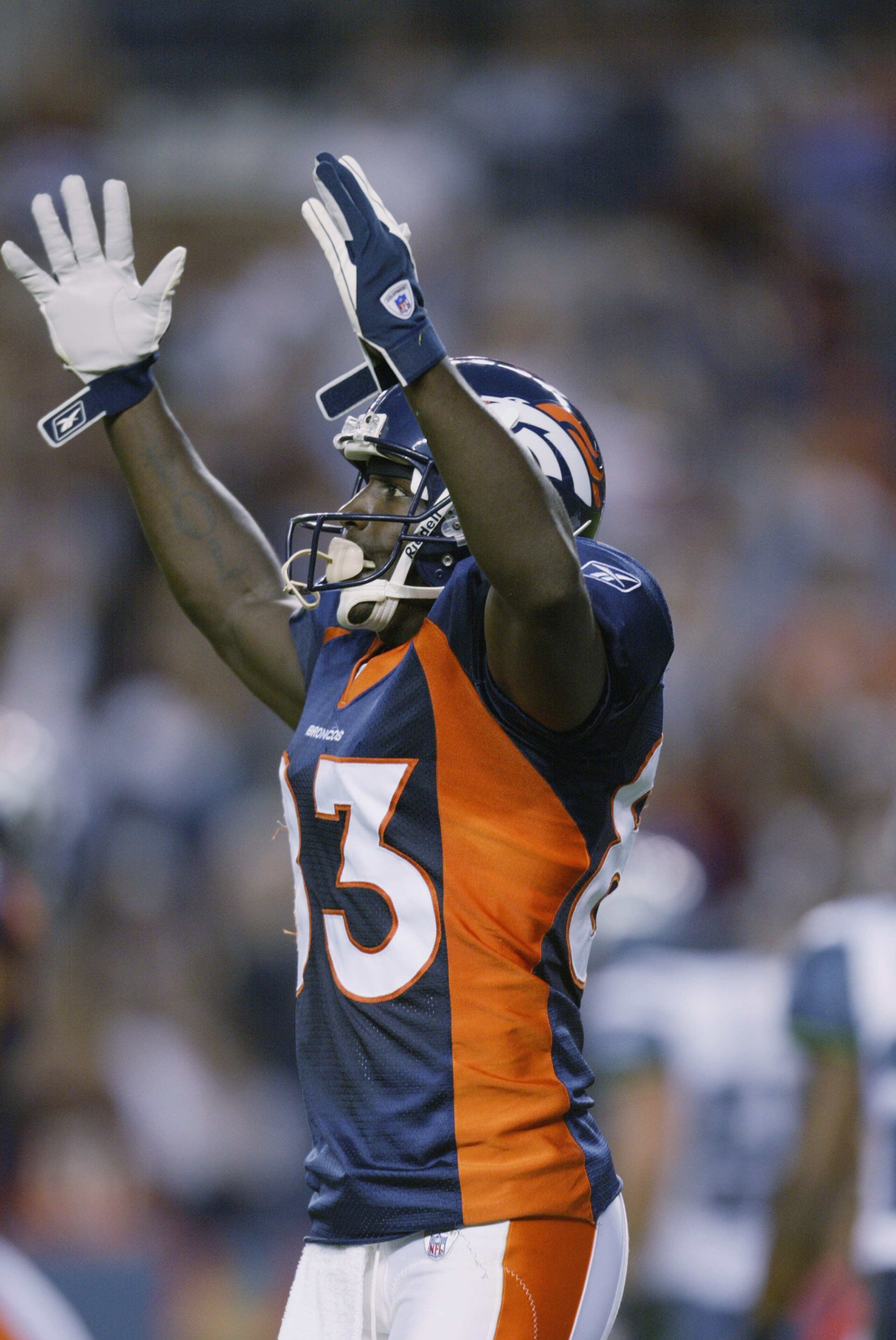 DENVER - AUGUST 29:  Wide receiver Scottie Montgomery #83 of the Denver Broncos signals the touchdown against the Seattle Seahawks on August 29, 2002 at Mile High Stadium in Denver, Colorado.  The Broncos beat the Seahawks 31-6.   (Photo by Brian Bahr/Get