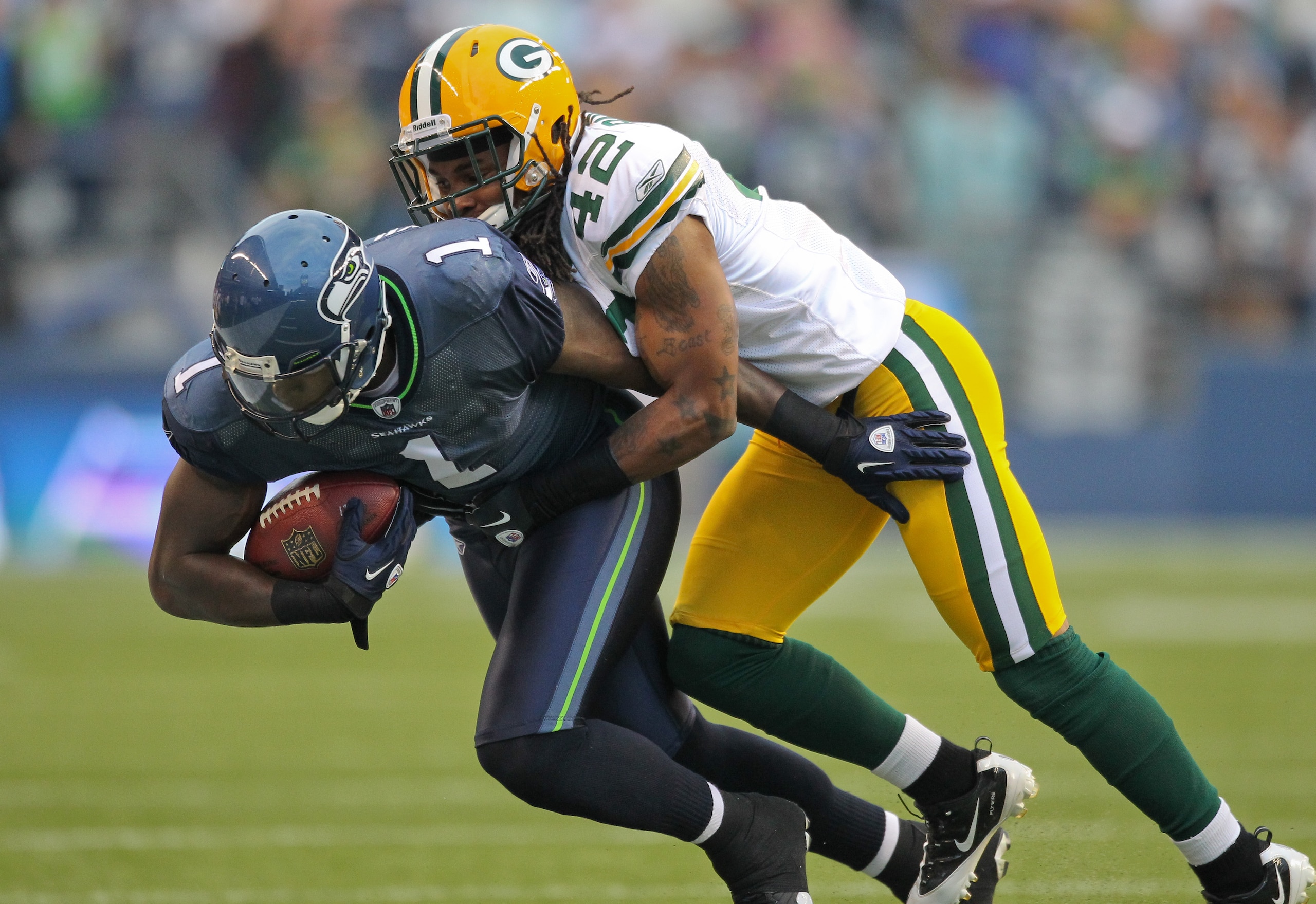 SEATTLE - AUGUST 21:  Wide receiver Mike Williams #1 of the Seattle Seahawks is tackled during the preseason game by Morgan Burnett #42 of the Green Bay Packers at Qwest Field on August 21, 2010 in Seattle, Washington. (Photo by Otto Greule Jr/Getty Image