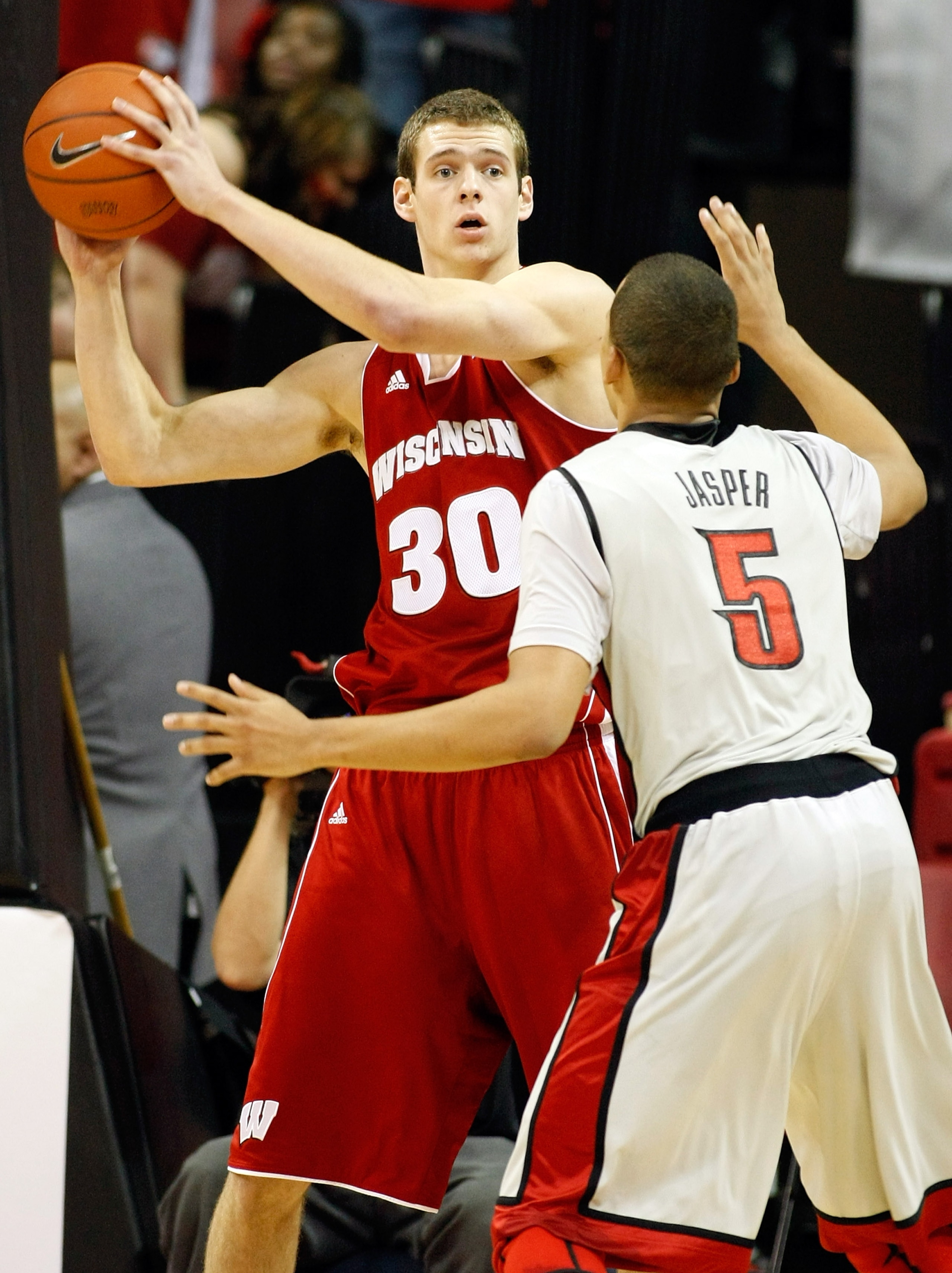 LAS VEGAS - NOVEMBER 20: Jon Leuer #30 of the Wisconsin Badgers looks to pass the ball inbounds as Derrick Jasper #5 of the UNLV Rebels defends during their game at the Thomas & Mack Center November 20, 2010 in Las Vegas, Nevada. UNLV won 68-65. (Photo LAS VEGAS - NOVEMBER 20: Jon Leuer #30 of the Wisconsin Badgers looks to pass the ball inbounds as Derrick Jasper #5 of the UNLV Rebels defends during their game at the Thomas & Mack Center November 20, 2010 in Las Vegas, Nevada. UNLV won 68-65. (Photo