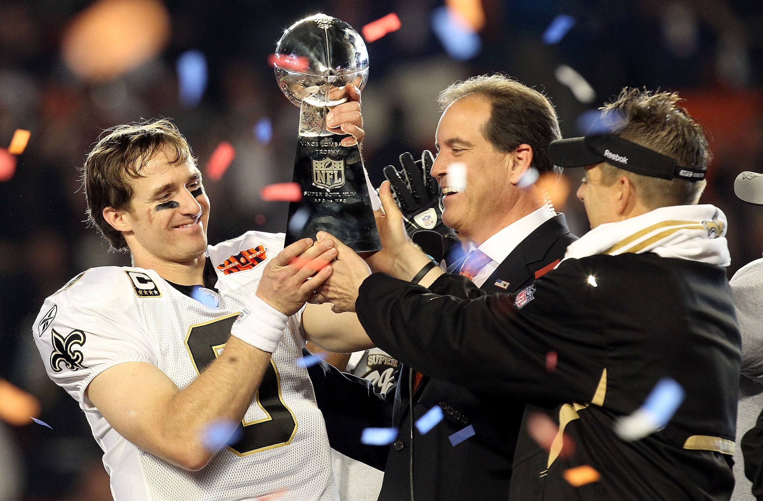 MIAMI GARDENS, FL - FEBRUARY 07: Head coach Sean Payton of the New Orleans Saints passes quarterback Drew Brees #9 the Vince Lombardi trophy after defeating the Indianapolis Colts during Super Bowl XLIV on February 7, 2010 at Sun Life Stadium in Miami Ga MIAMI GARDENS, FL - FEBRUARY 07: Head coach Sean Payton of the New Orleans Saints passes quarterback Drew Brees #9 the Vince Lombardi trophy after defeating the Indianapolis Colts during Super Bowl XLIV on February 7, 2010 at Sun Life Stadium in Miami Ga