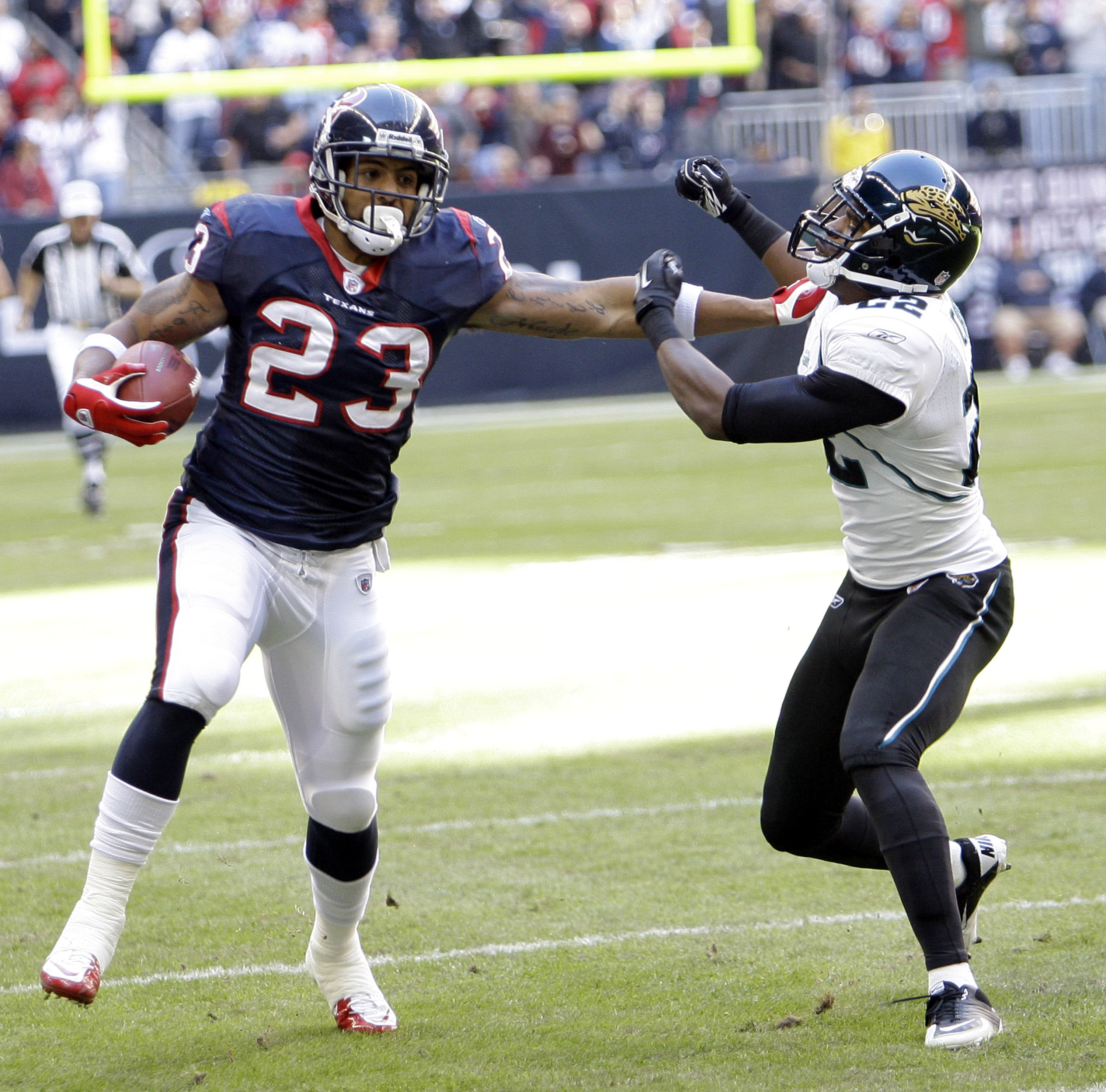 HOUSTON - JANUARY 02: Running back Arian Foster #23 of the Houston Texans gives Don Carey #22 of the Jacksonville Jaguars a stiff arm at Reliant Stadium on January 2, 2011 in Houston, Texas. (Photo by Bob Levey/Getty Images) HOUSTON - JANUARY 02: Running back Arian Foster #23 of the Houston Texans gives Don Carey #22 of the Jacksonville Jaguars a stiff arm at Reliant Stadium on January 2, 2011 in Houston, Texas. (Photo by Bob Levey/Getty Images)