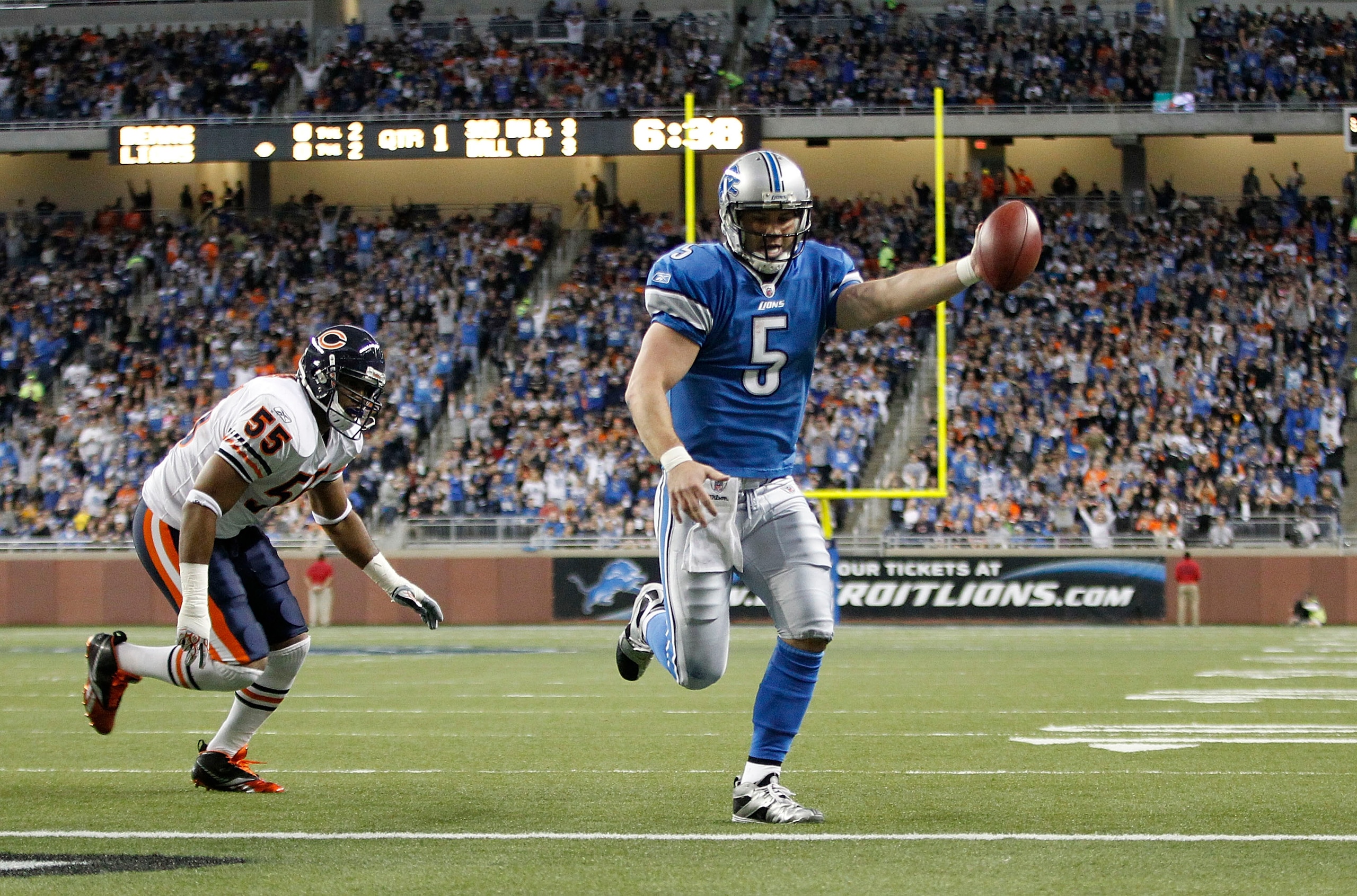 DETROIT - DECEMBER 05: Drew Stanton #5 of the Detroit Lions runs three yards for a first quarter touchdown as Lance Briggs #55 of the Chicago Bears gives chase during the game at Ford Field on December 5, 2010 in Detroit, Michigan.  (Photo by Leon Halip/G