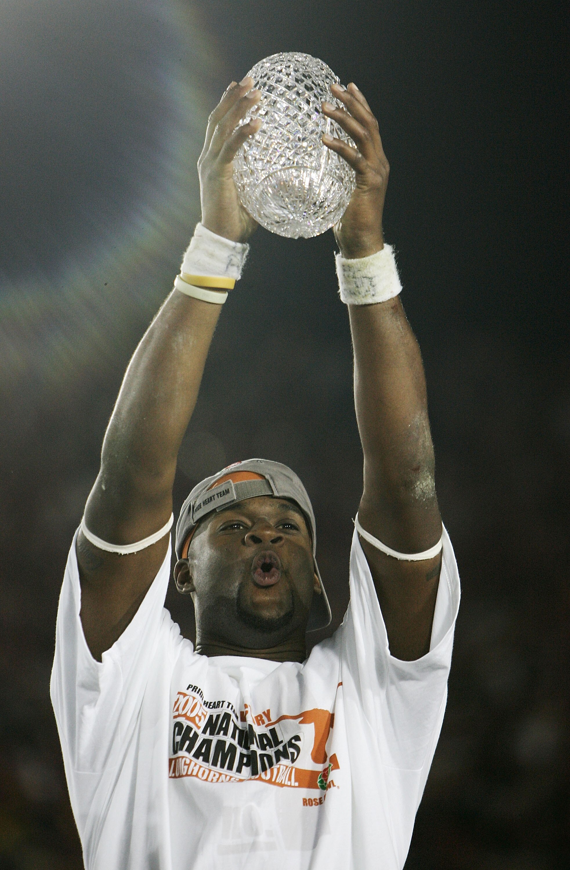 PASADENA, CA - JANUARY 04:  Quarterback Vince Young #10 of the Texas Longhorns celebrates with the National Champtionship trophy after defeating the USC Trojans 41-38 to win the BCS National Championship Rose Bowl Game on January 4, 2006 in Pasadena, Cali