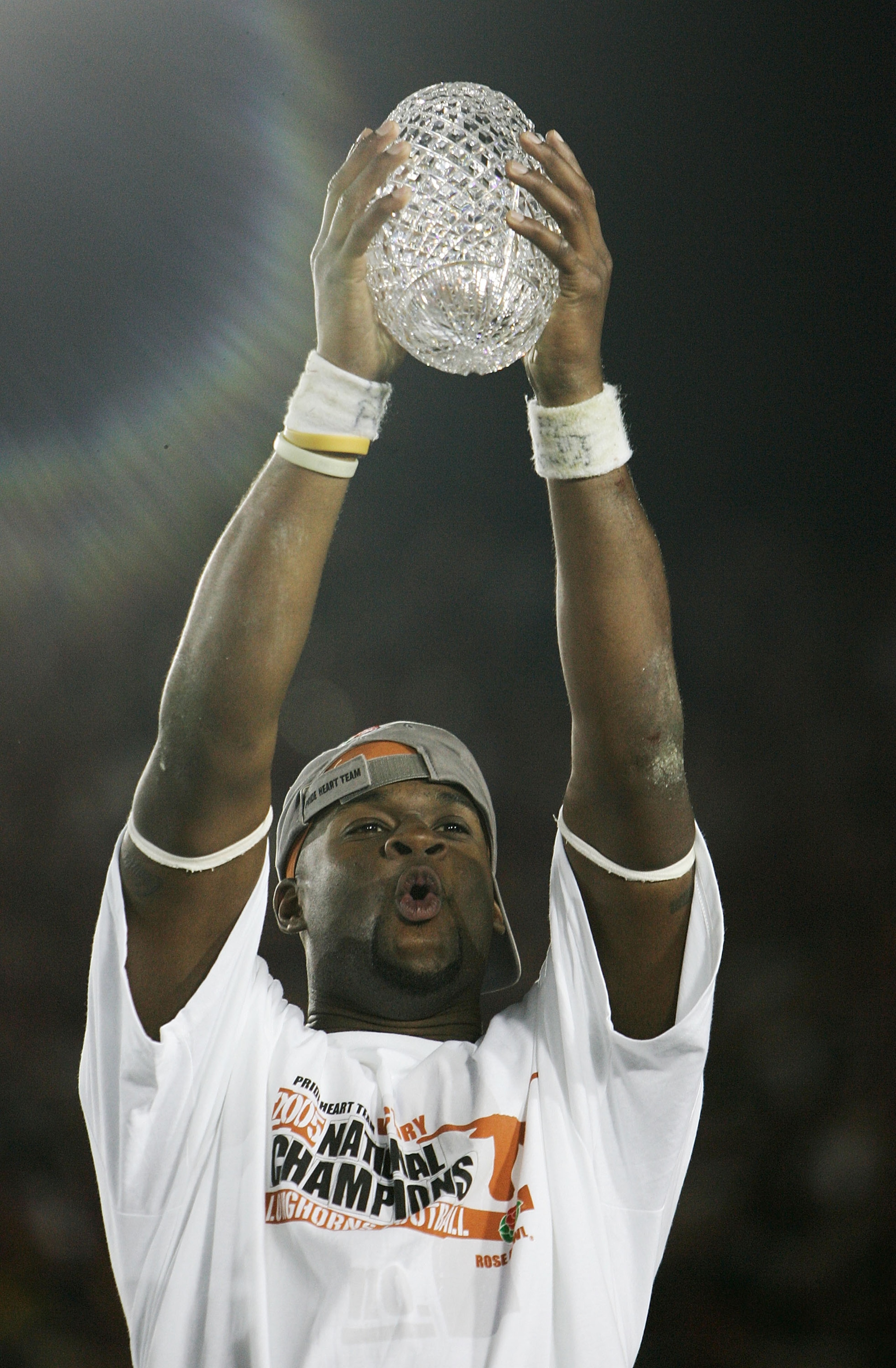 PASADENA, CA - JANUARY 04:  Quarterback Vince Young #10 of the Texas Longhorns celebrates with the National Champtionship trophy after defeating the USC Trojans 41-38 to win the BCS National Championship Rose Bowl Game on January 4, 2006 in Pasadena, Cali