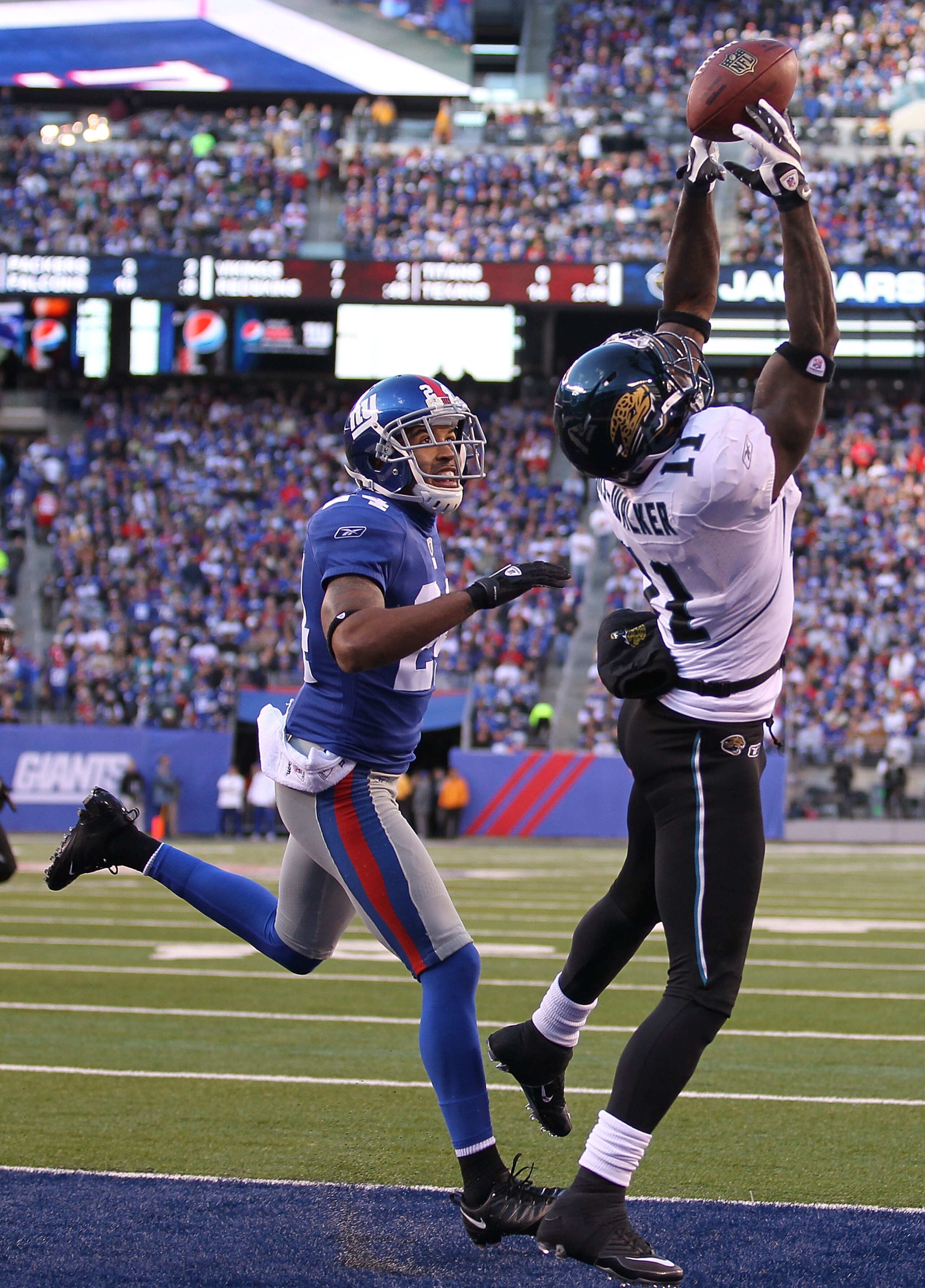 EAST RUTHERFORD, NJ - NOVEMBER 28:  Mike Sims Walker #11 of the Jacksonville Jaguars misses the ball as Terrell Thomas #24 of the New York Giants defends during their game on November 28, 2010 at The New Meadowlands Stadium in East Rutherford, New Jersey.