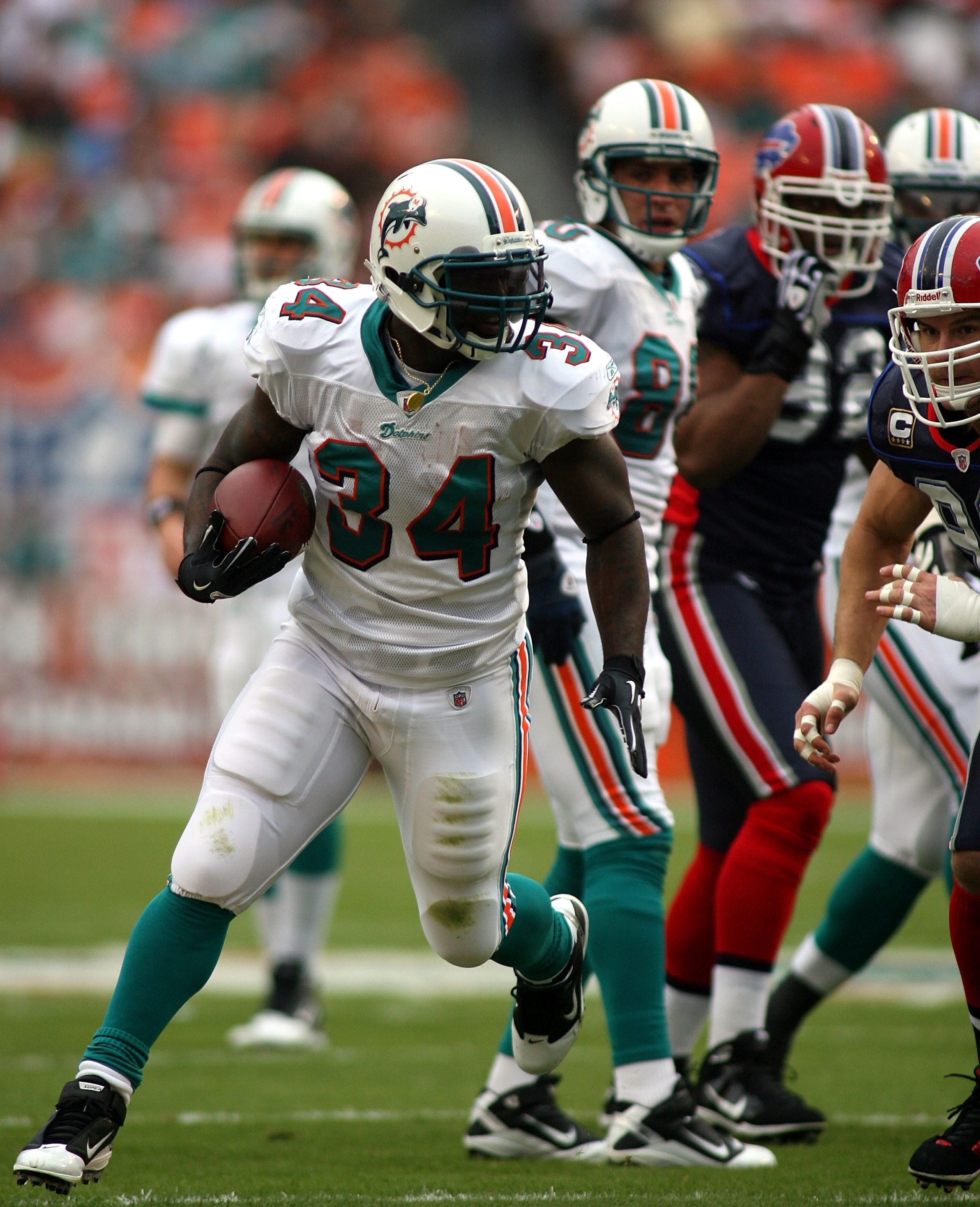 MIAMI - DECEMBER 19:  Running back Ricky Williams #34  of the Miami Dolphins is upended by the Buffalo Bills at Sun Life Stadium on December 19, 2010 in Miami, Florida. The Bills defeated the Dolphins 17-14.  (Photo by Marc Serota/Getty Images)