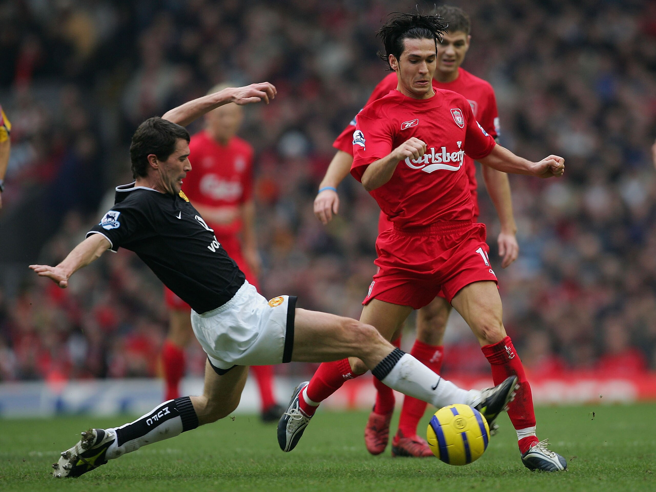LIVERPOOL, ENGLAND - JANUARY 15:  Roy Keane of Manchester United tackles Luis Garcia of Liverpool during the Barclays Premiership match between Liverpool and Manchester United at Anfield on January 15, 2004 in Manchester, England.  (Photo by Alex Livesey/